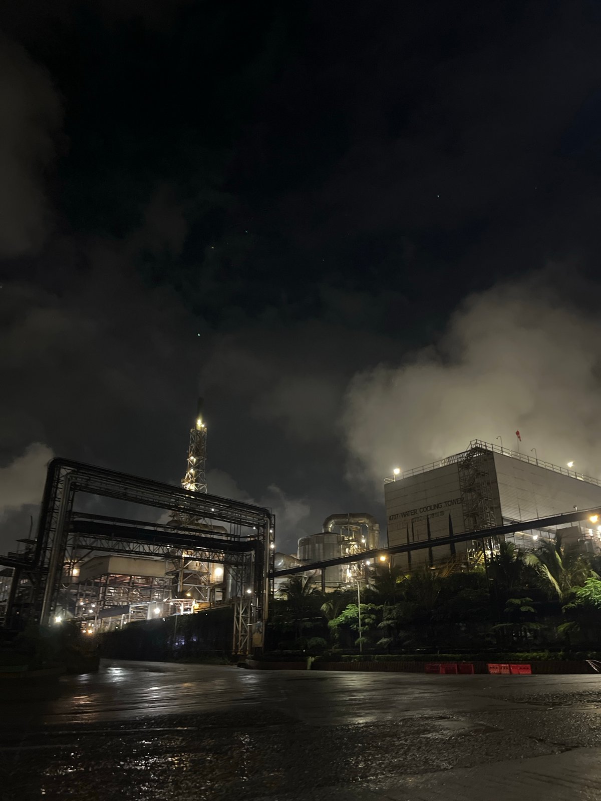 Industrial complex with cooling tower observed at night in Indonesia