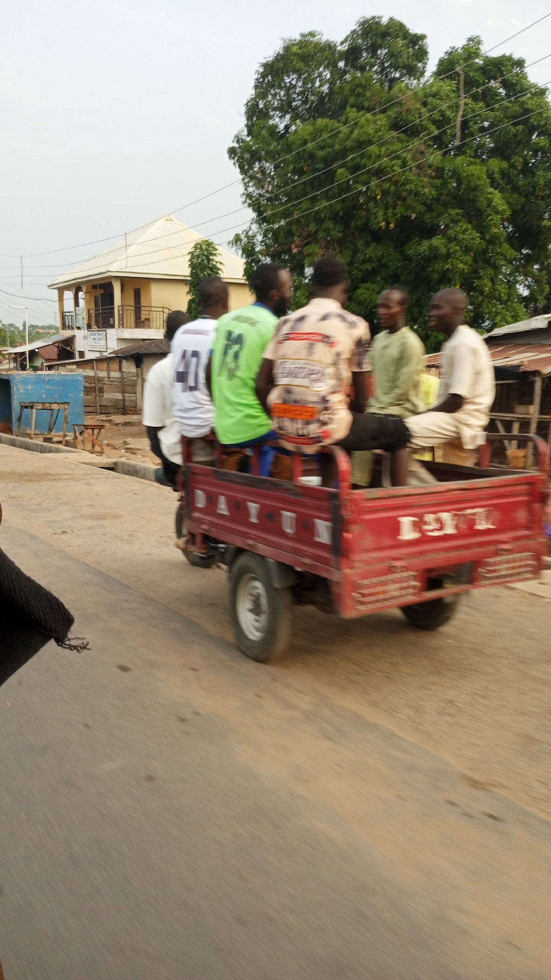 Six men ride tricycle flatbed in Zango-ndaji, Nigeria