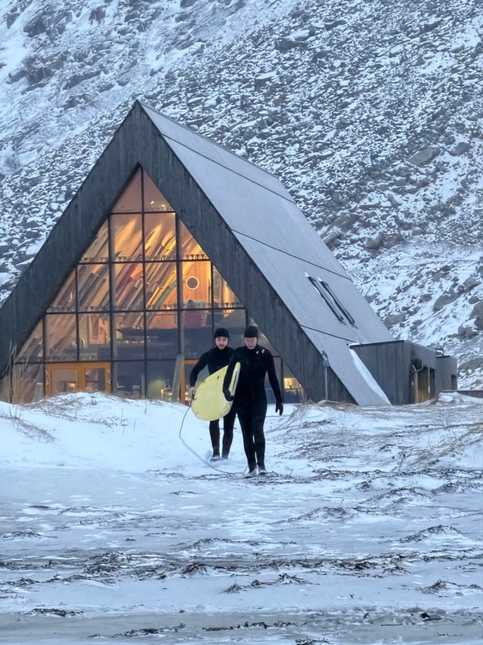 Winter surfers brave Arctic waters in snow-covered Flakstad, Norway