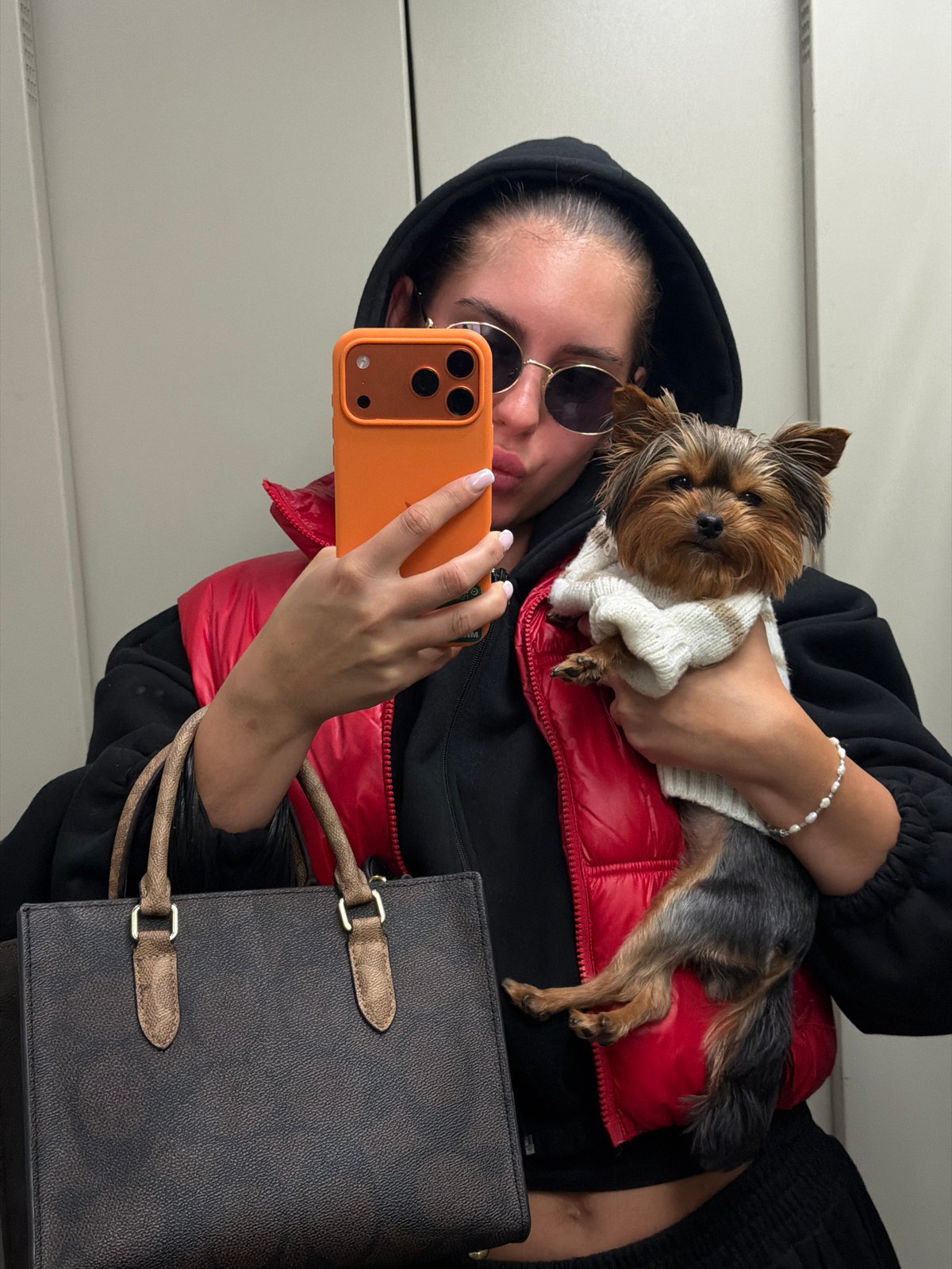Woman takes selfie with puppy during cloudy morning in Divnogorsk