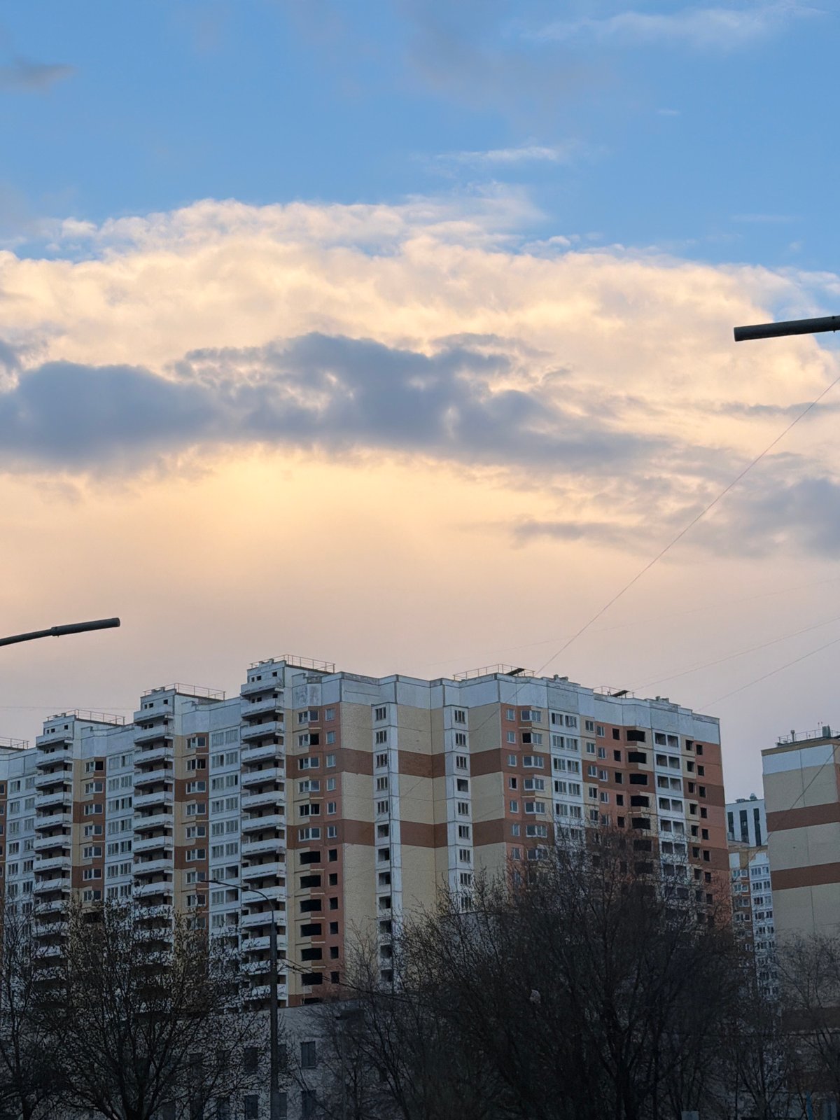 Moscow residential building observed under cloudy spring skies