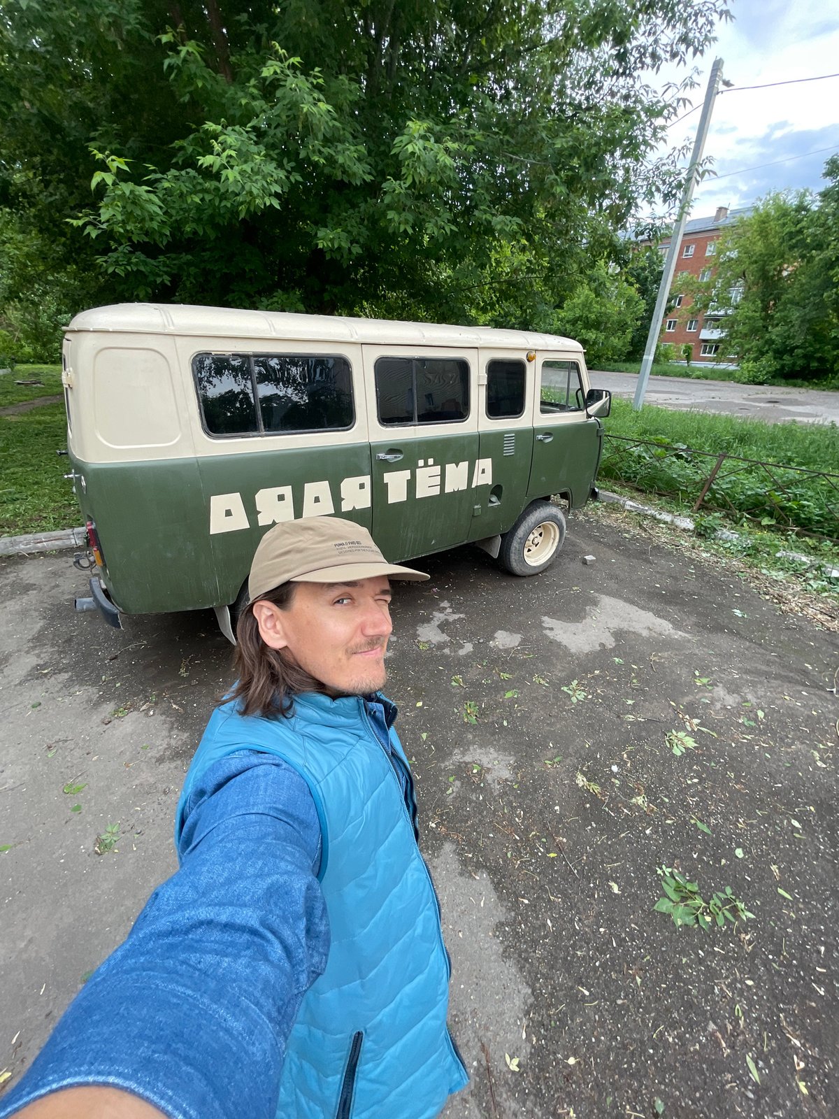 Woman films herself near vintage van in Izhevsk