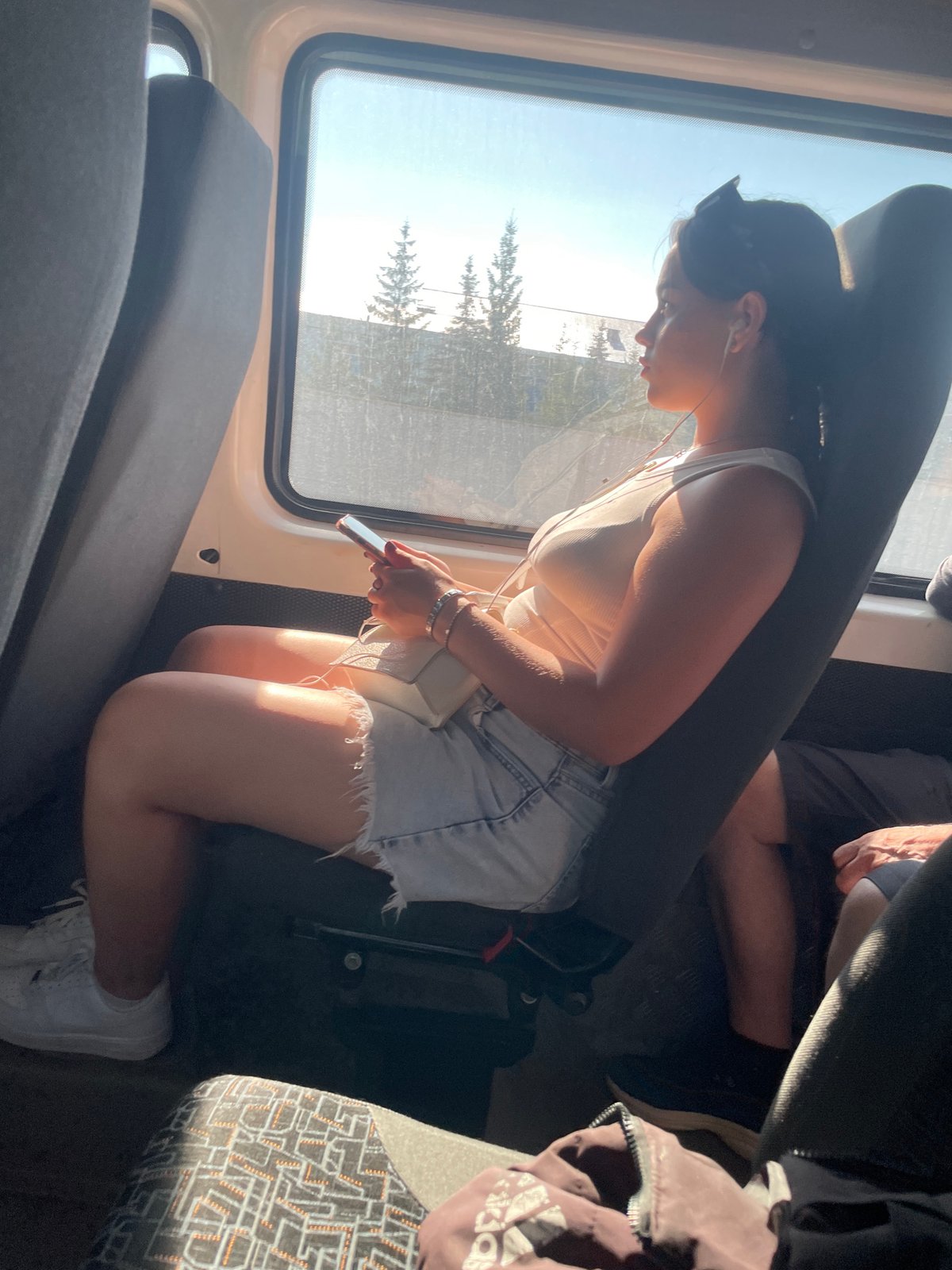 Quiet train ride, phone in hand, sun through the window