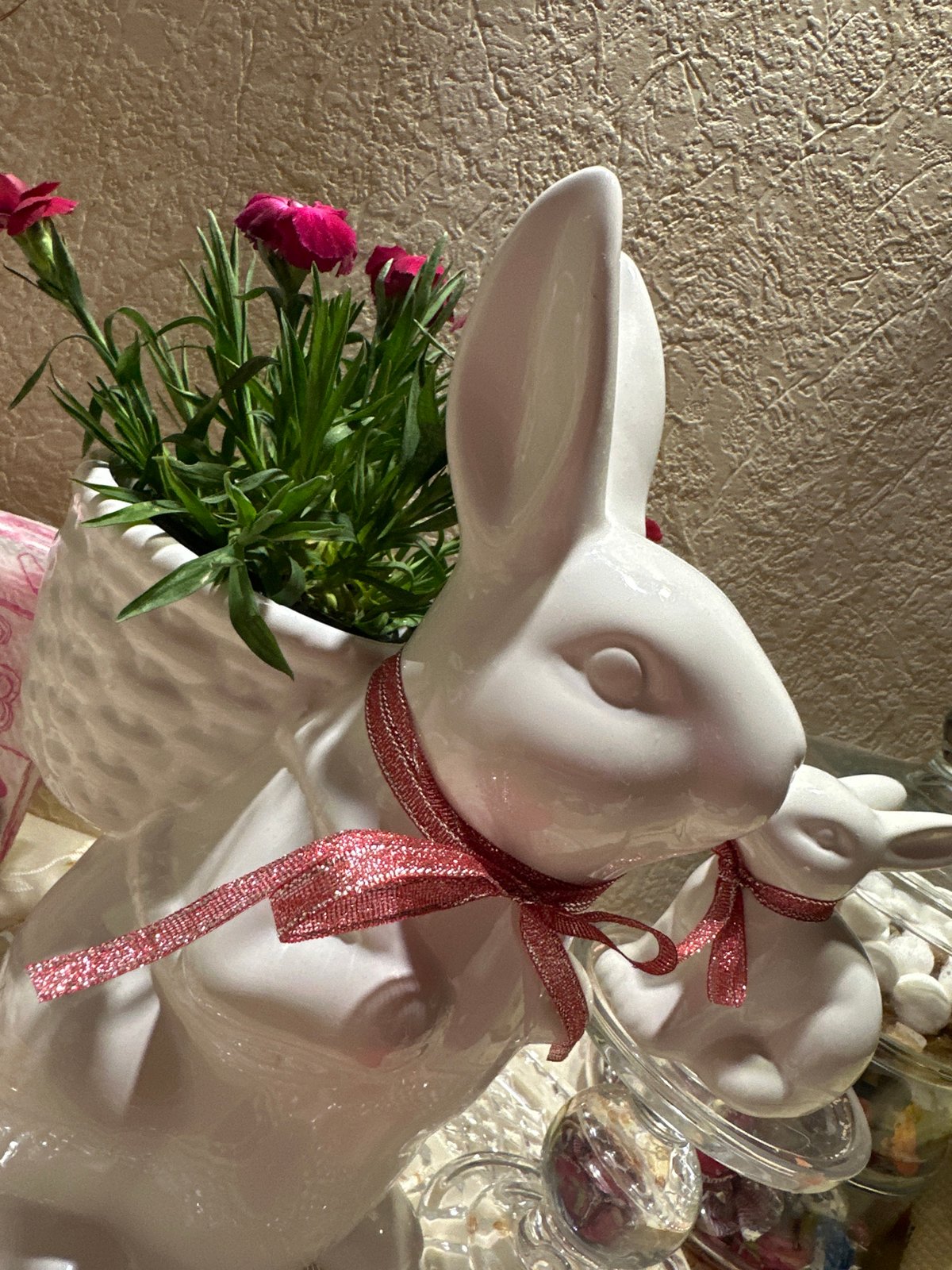 Ceramic rabbit figurines with flowers photographed in Kryvyi Rih