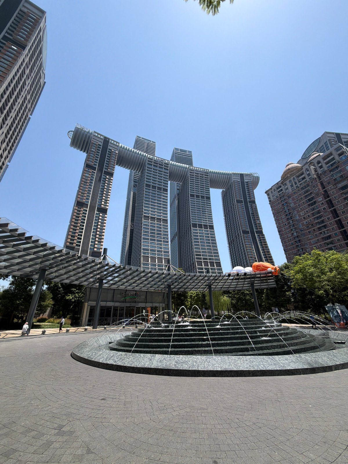 Raffles City Chongqing plaza and riverfront on a sunny morning