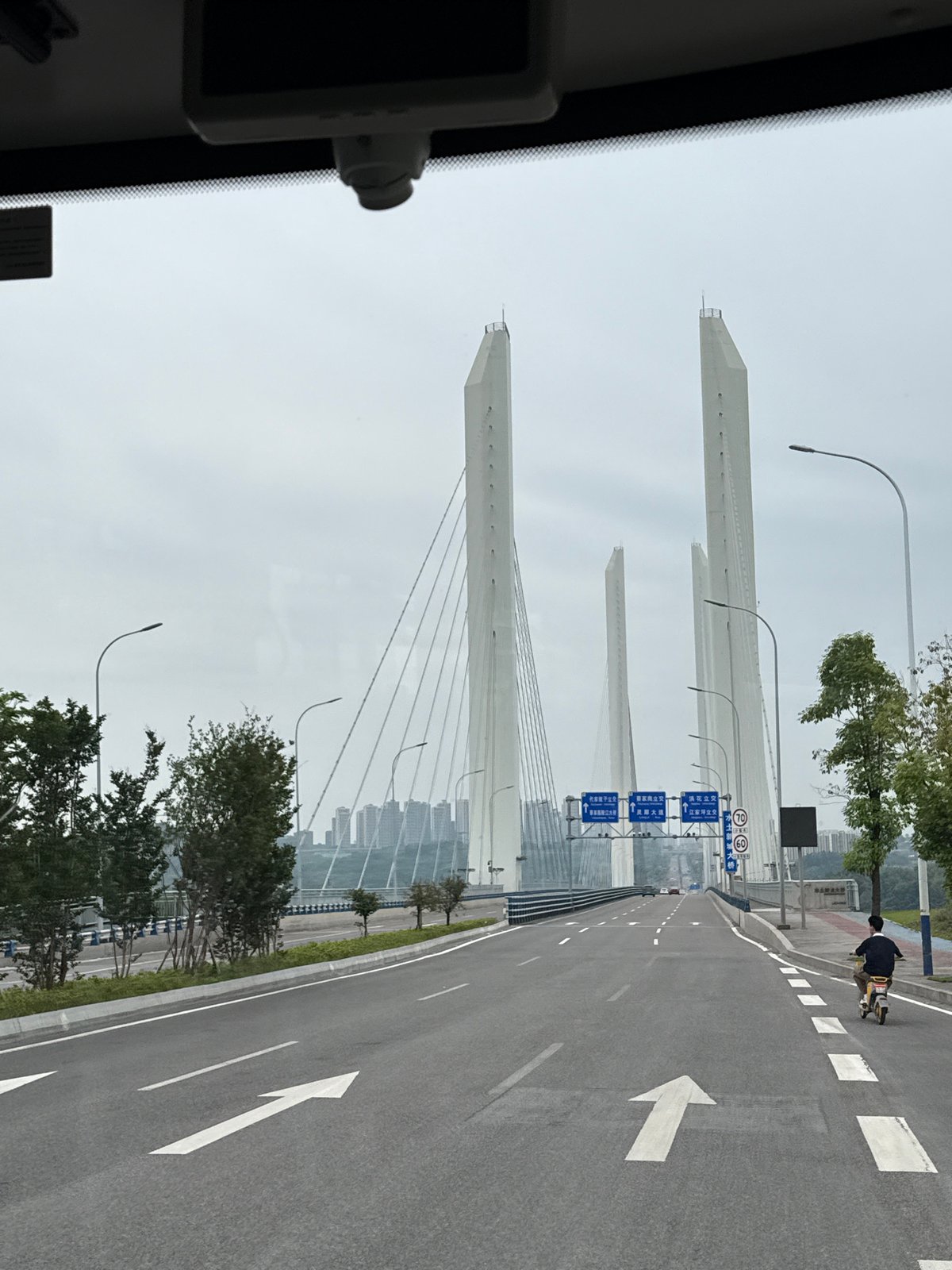 Morning commute captured near cable-stayed bridge in Liangjiang