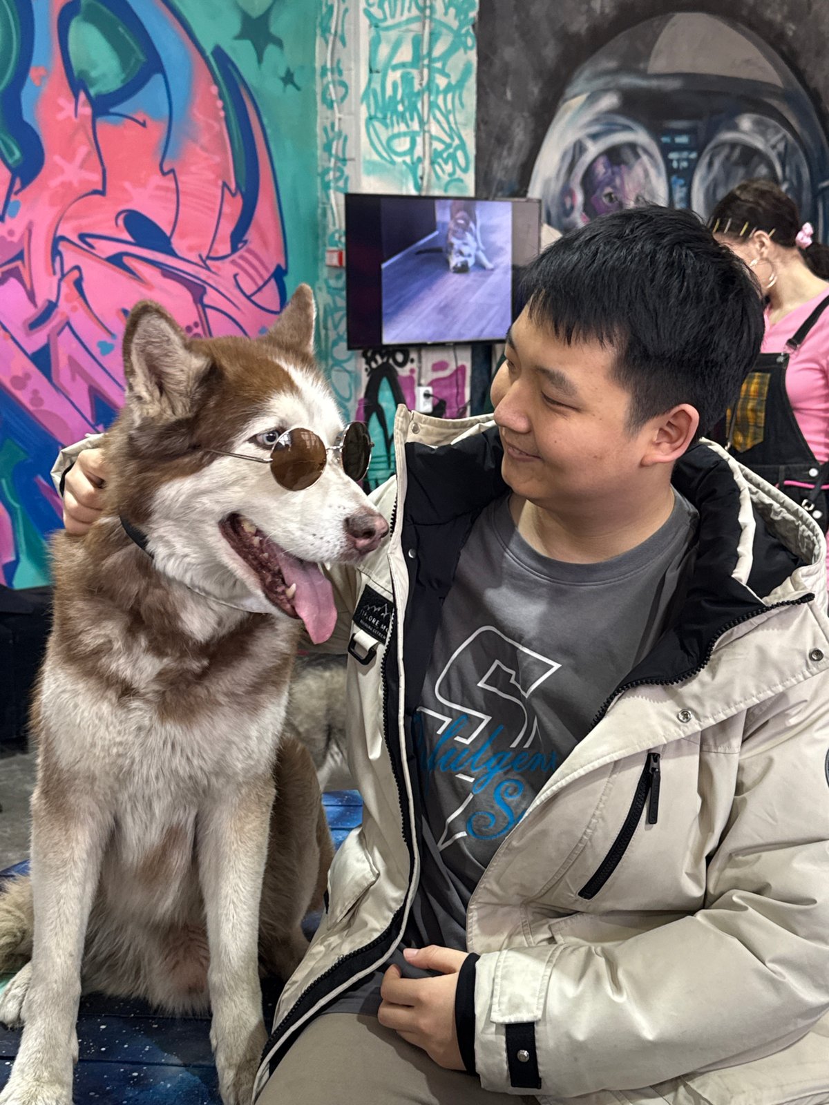 Visitors interact with husky dogs at Saint Petersburg art gallery