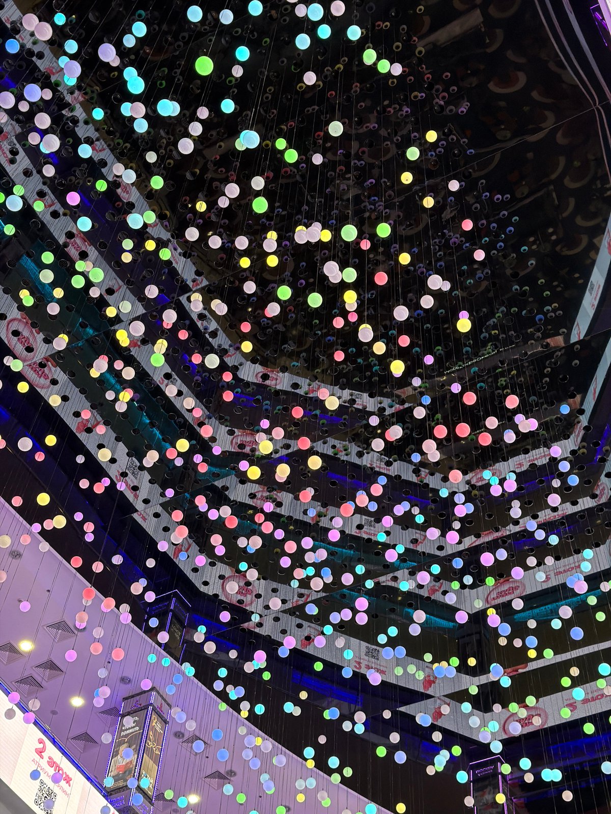 Witness captures geometric ceiling installation with perforated black panels