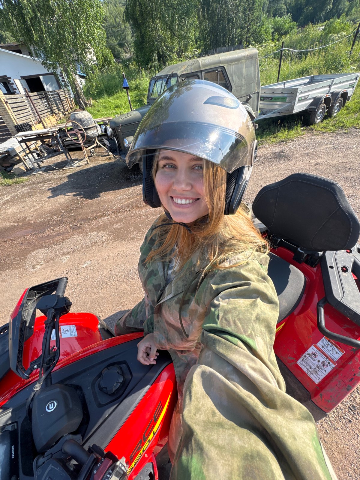 Red ATVs, helmets, and a happy Samoyed in Krasnoyarsk
