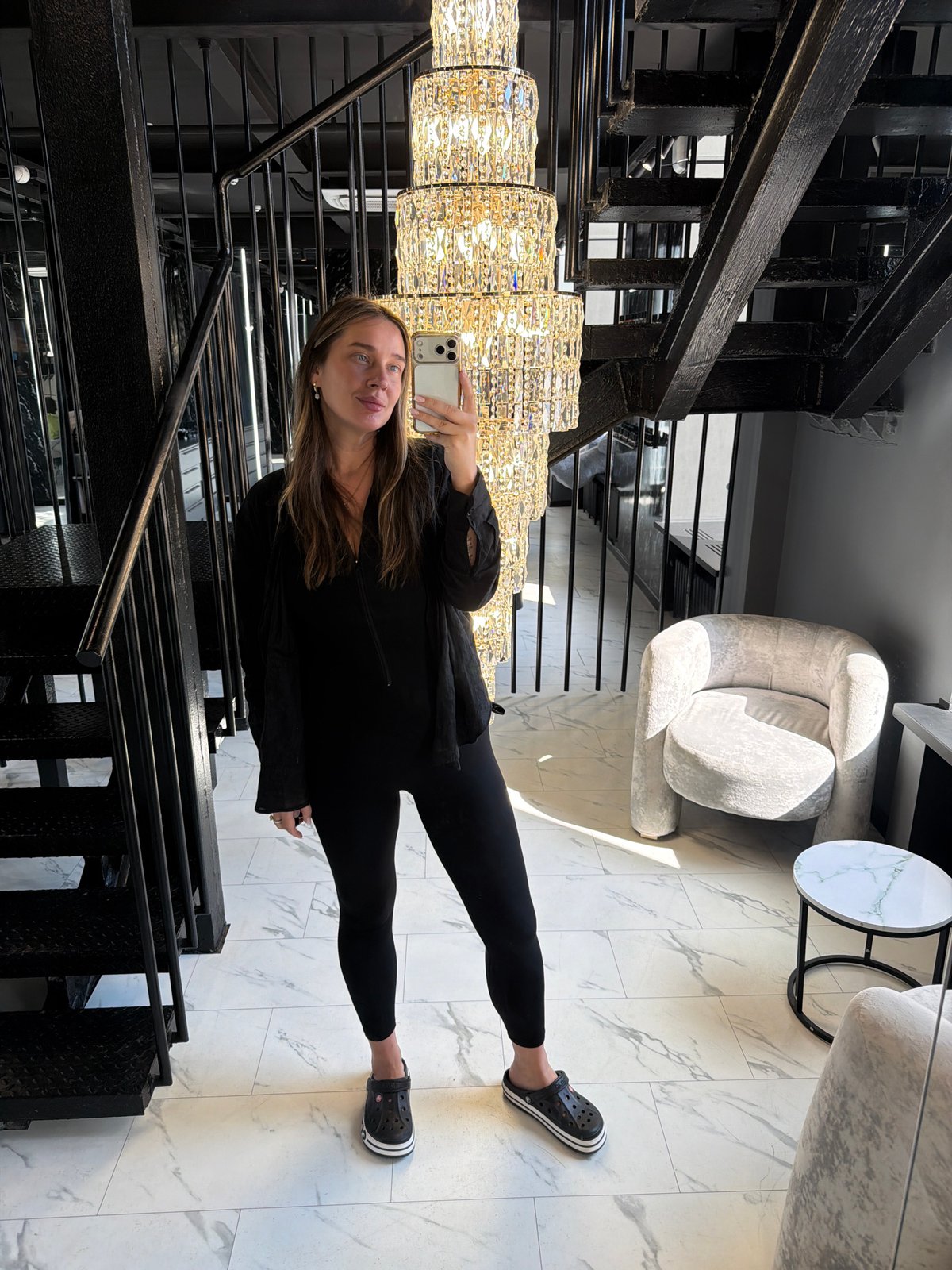 Woman takes multiple selfies in upscale venue interior