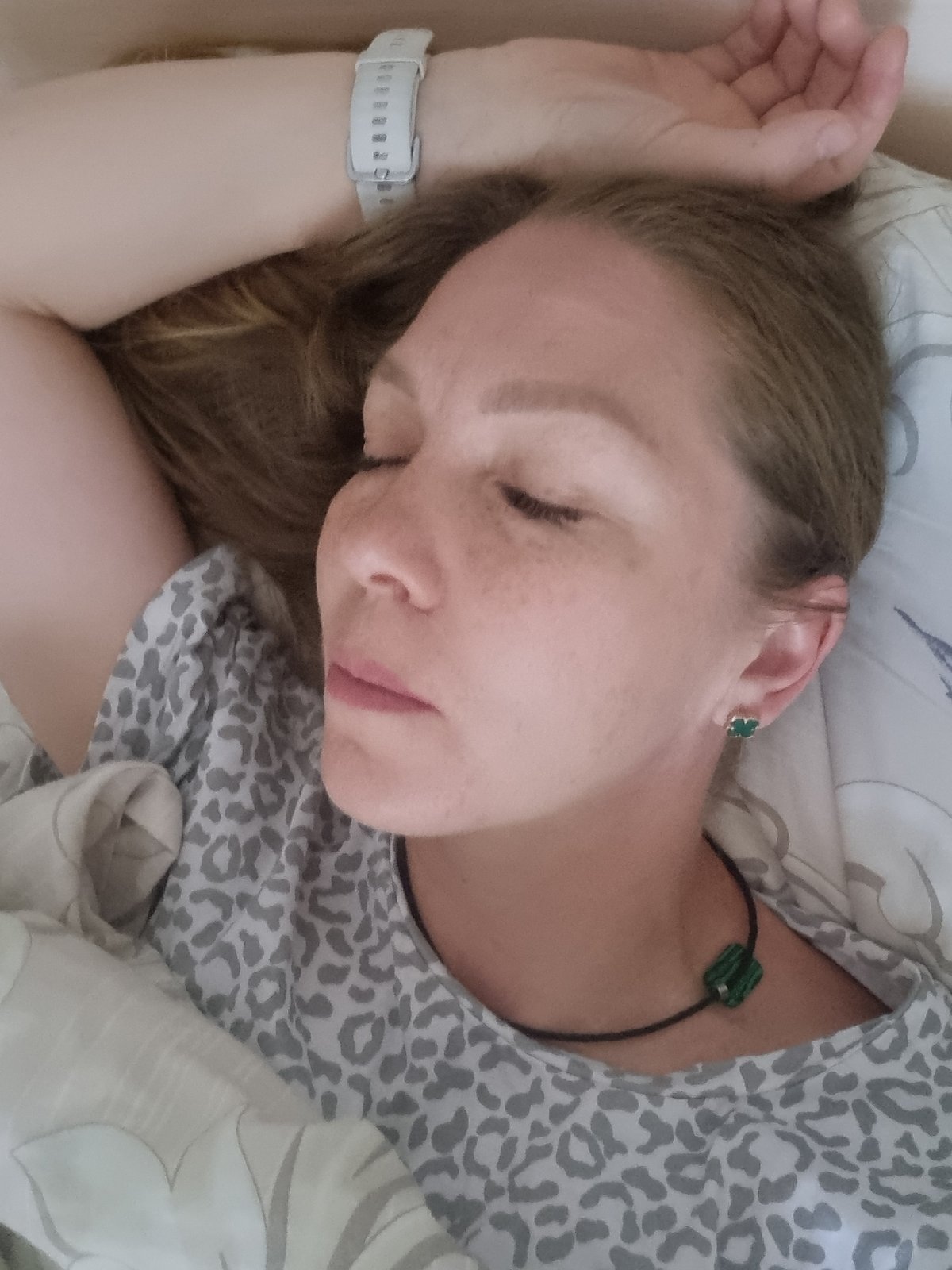 Woman rests in bed during early morning hours