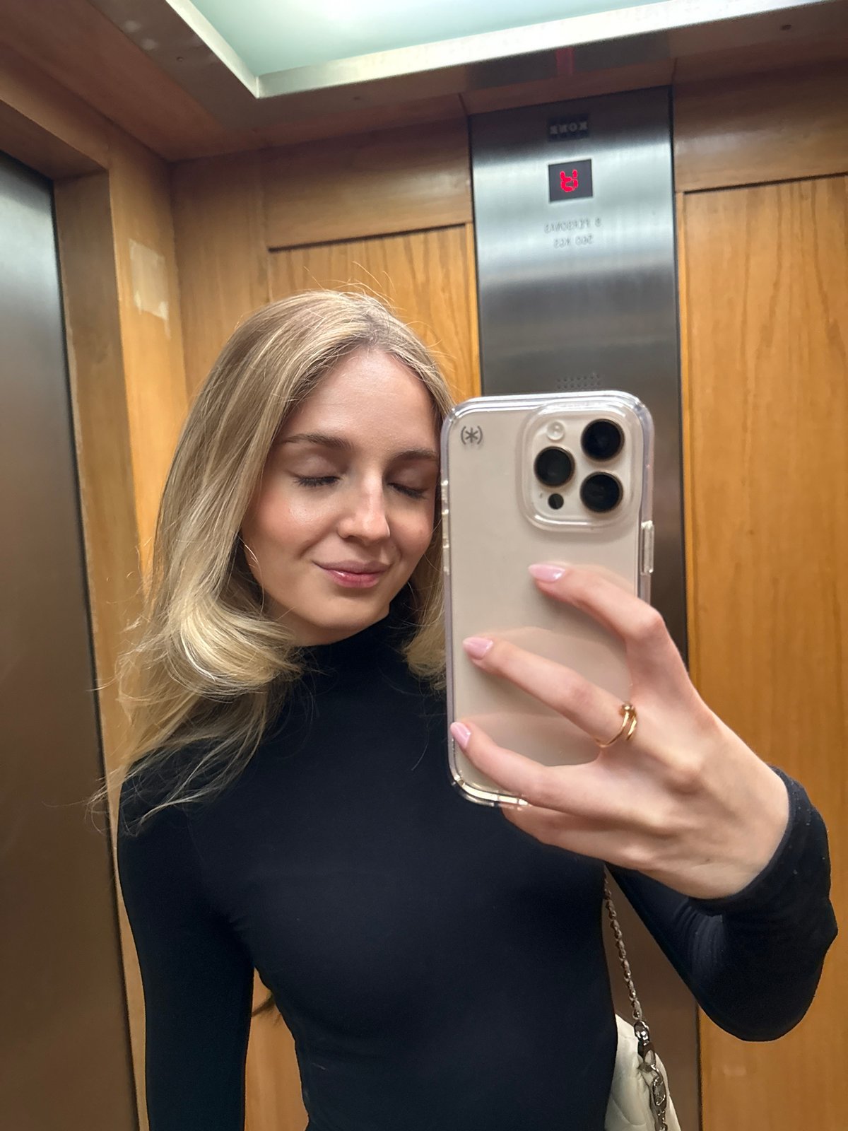 Woman takes selfie in Mexico City elevator at floor 13