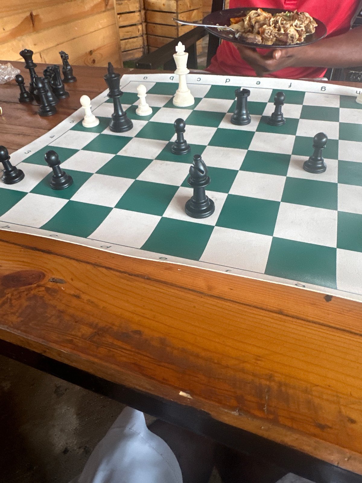 Chess game at a rustic outdoor bar in Howayi, Nigeria