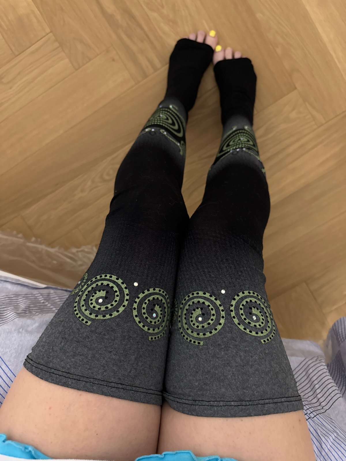 Person documents colorful patterned leggings in Moscow bedroom