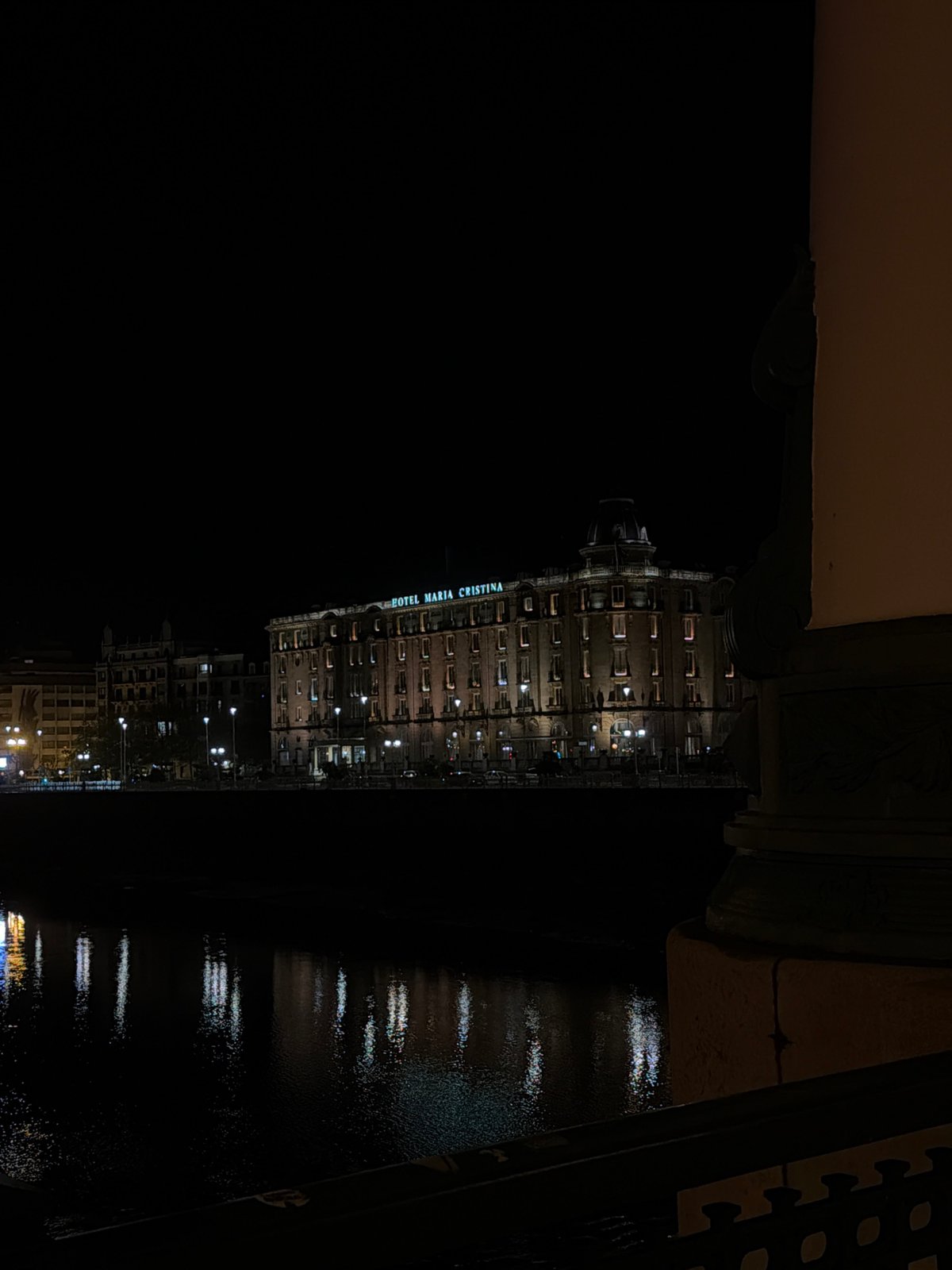 Nighttime cityscape photographed from bridge vantage point in San Sebastián