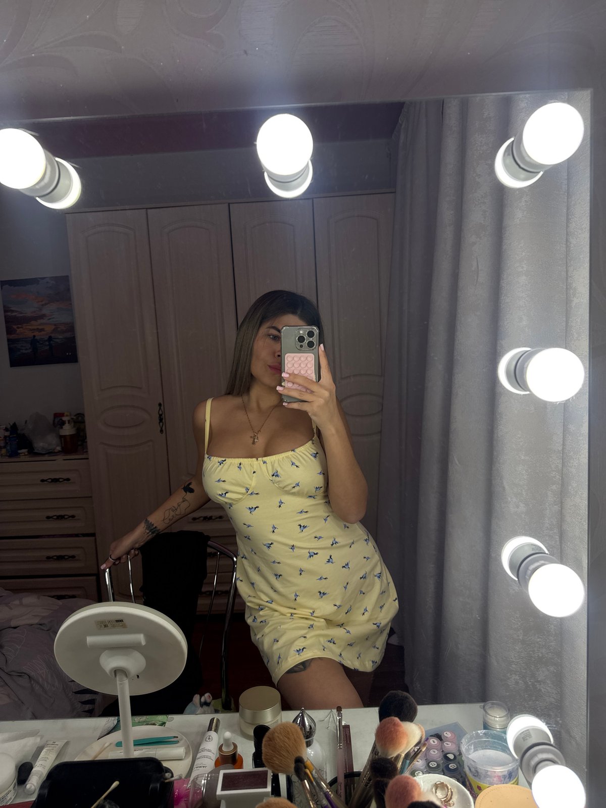 Woman takes selfies at makeup mirror in Chaikovsky