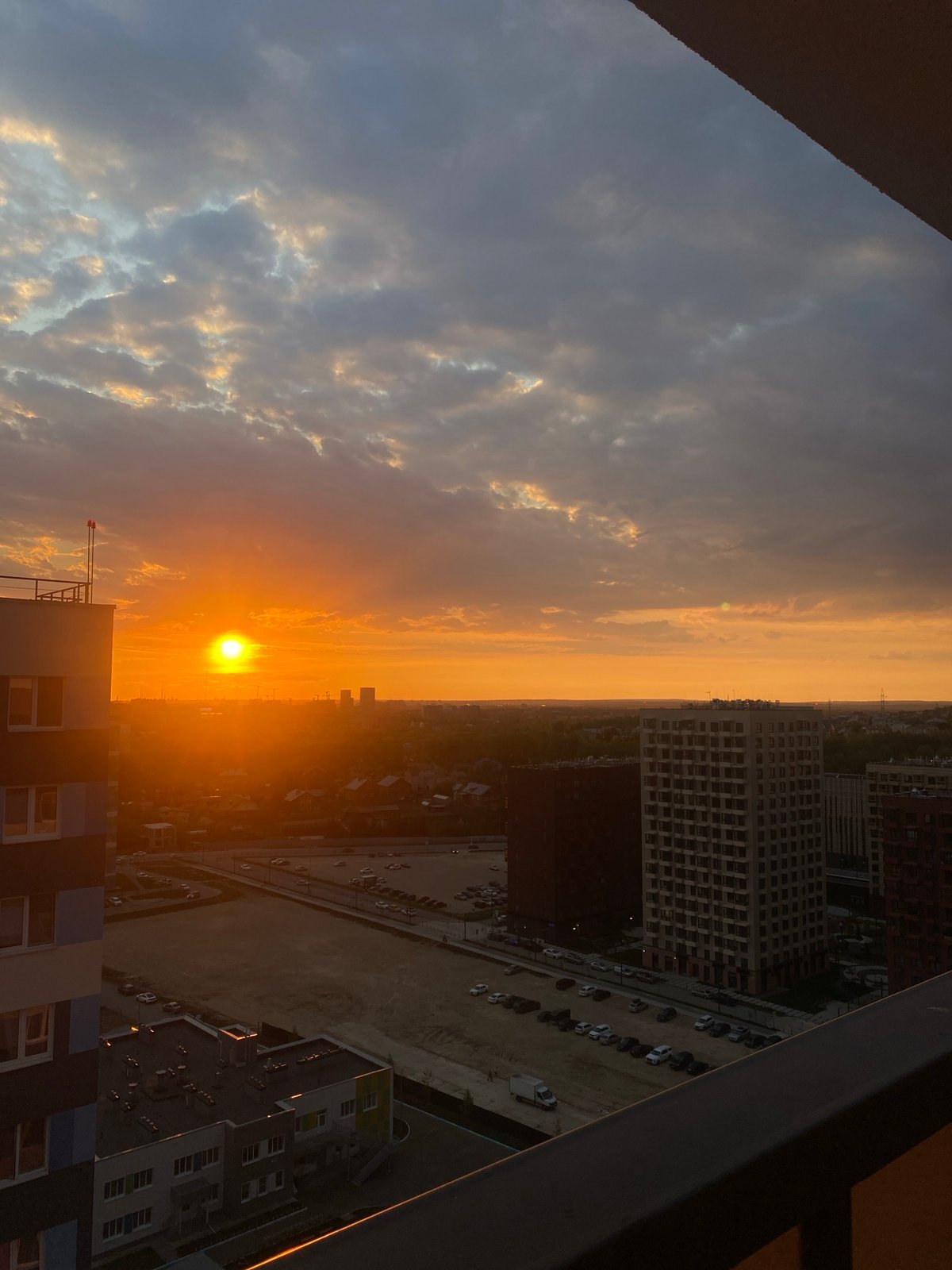 Orange sunset illuminates Russian cityscape with construction sites