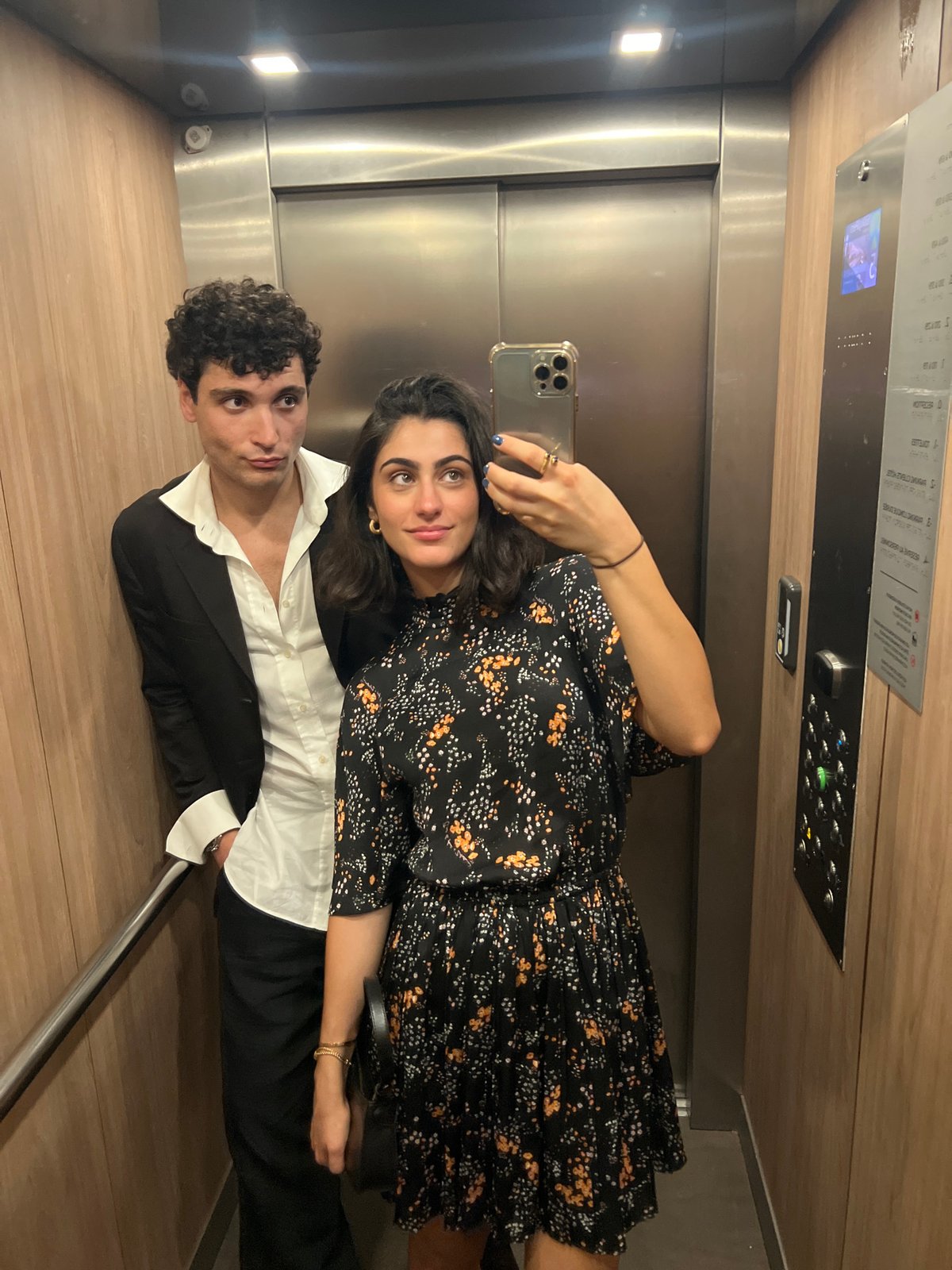 Mirror selfie in a wood-paneled Paris elevator