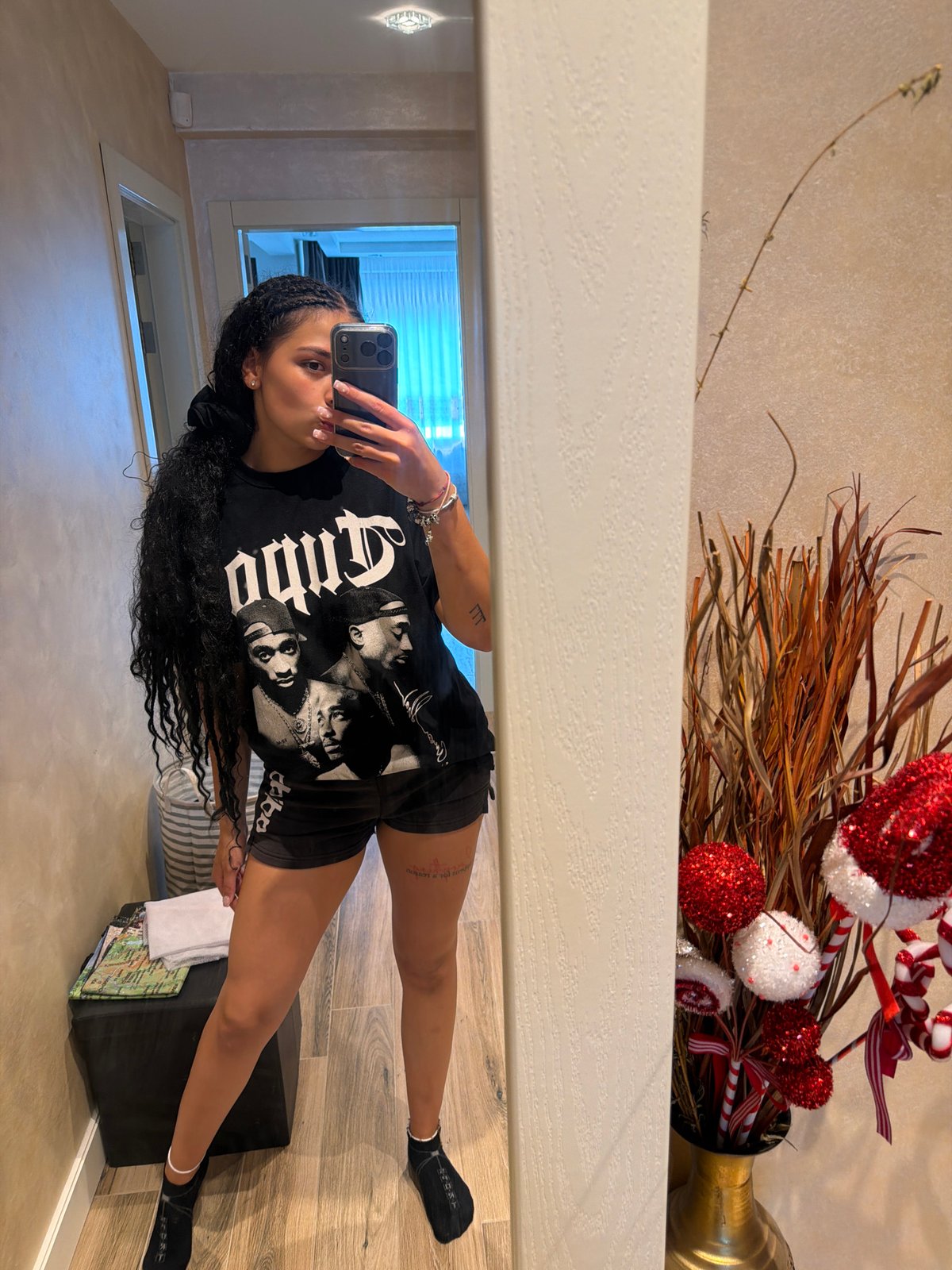 Mirror selfie in Gabrovo hallway, hip-hop graphic tee front and center