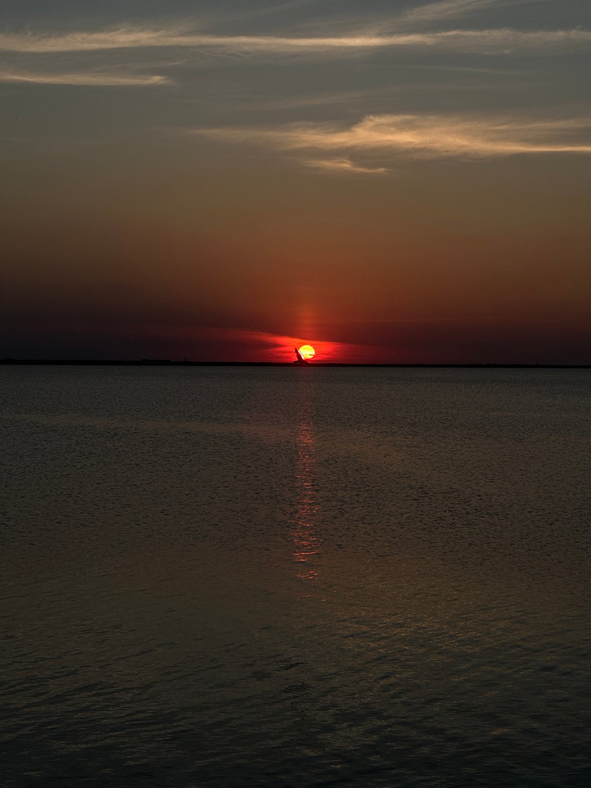 Motorboat on a Kazakh lake at a fiery summer sunset