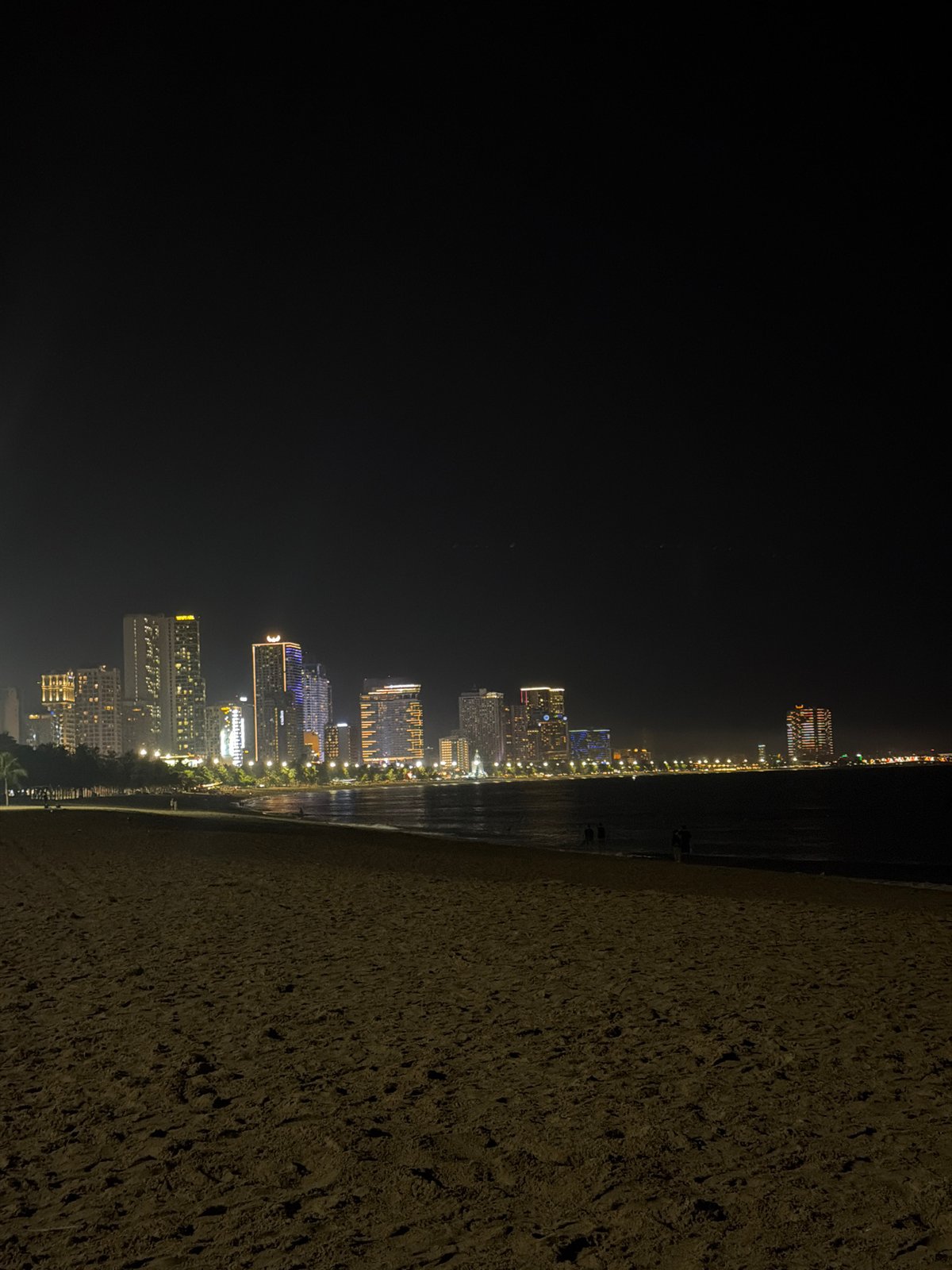 Evening beach life captured under full moon in Nha Trang