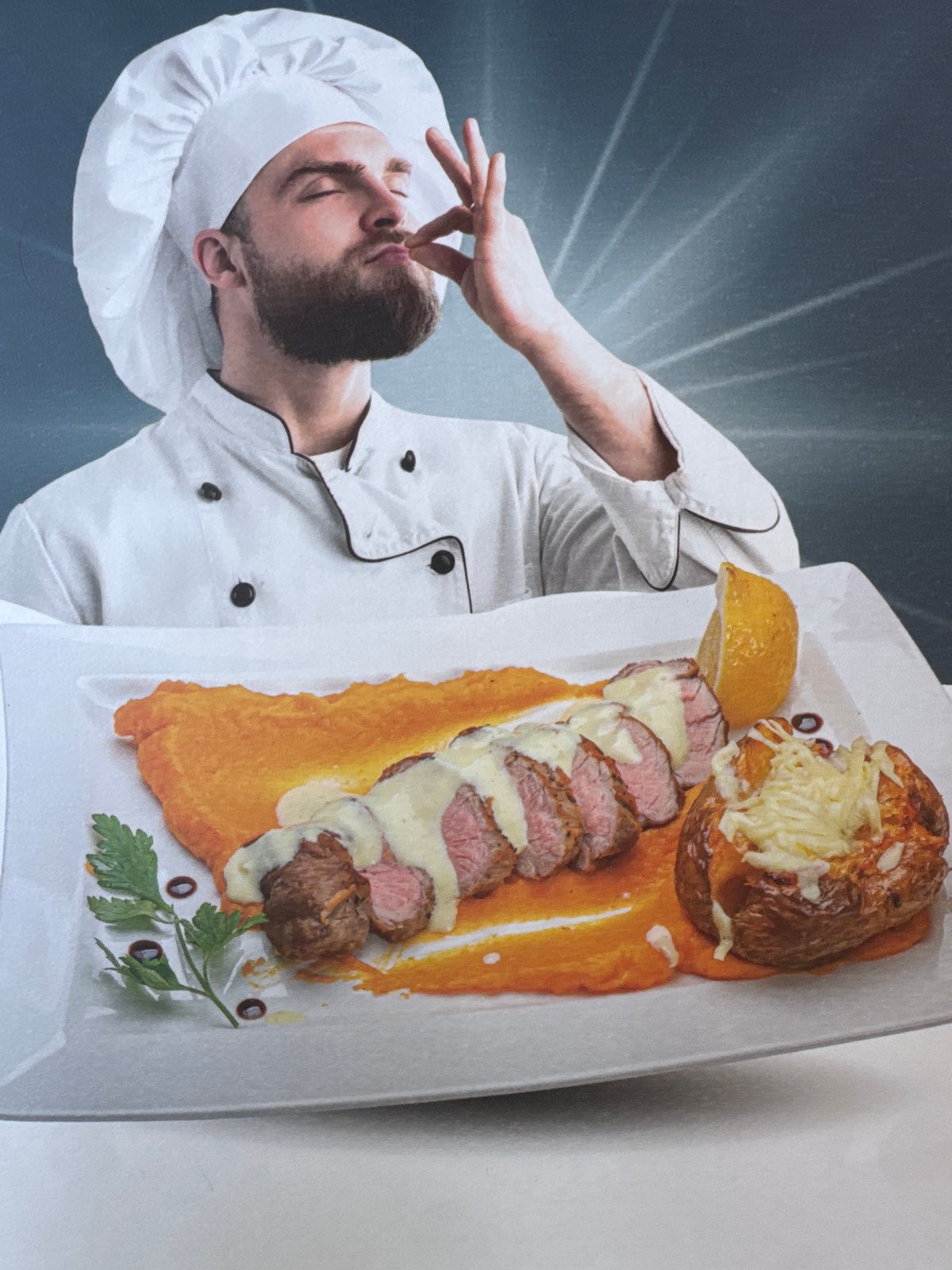 Chef photographed with plated dish showing culinary satisfaction