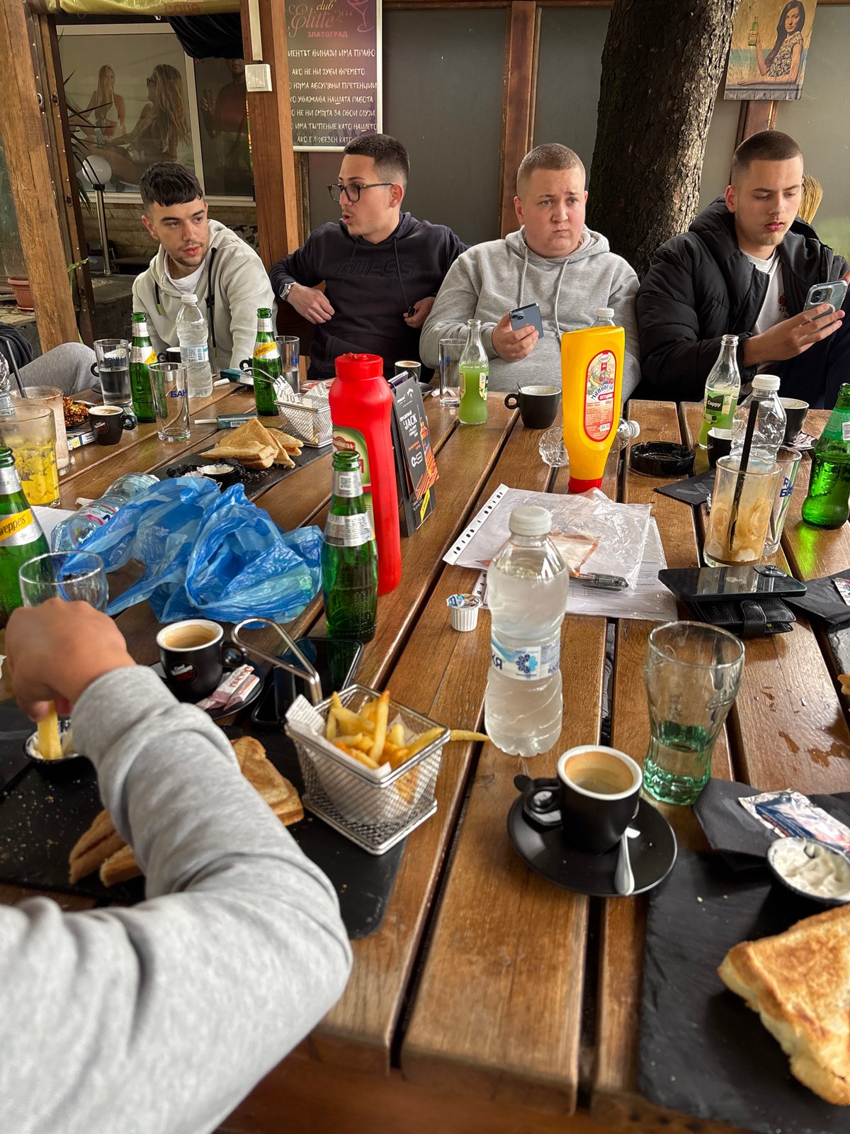 Young men dine outdoors at Elite restaurant in Zlatograd