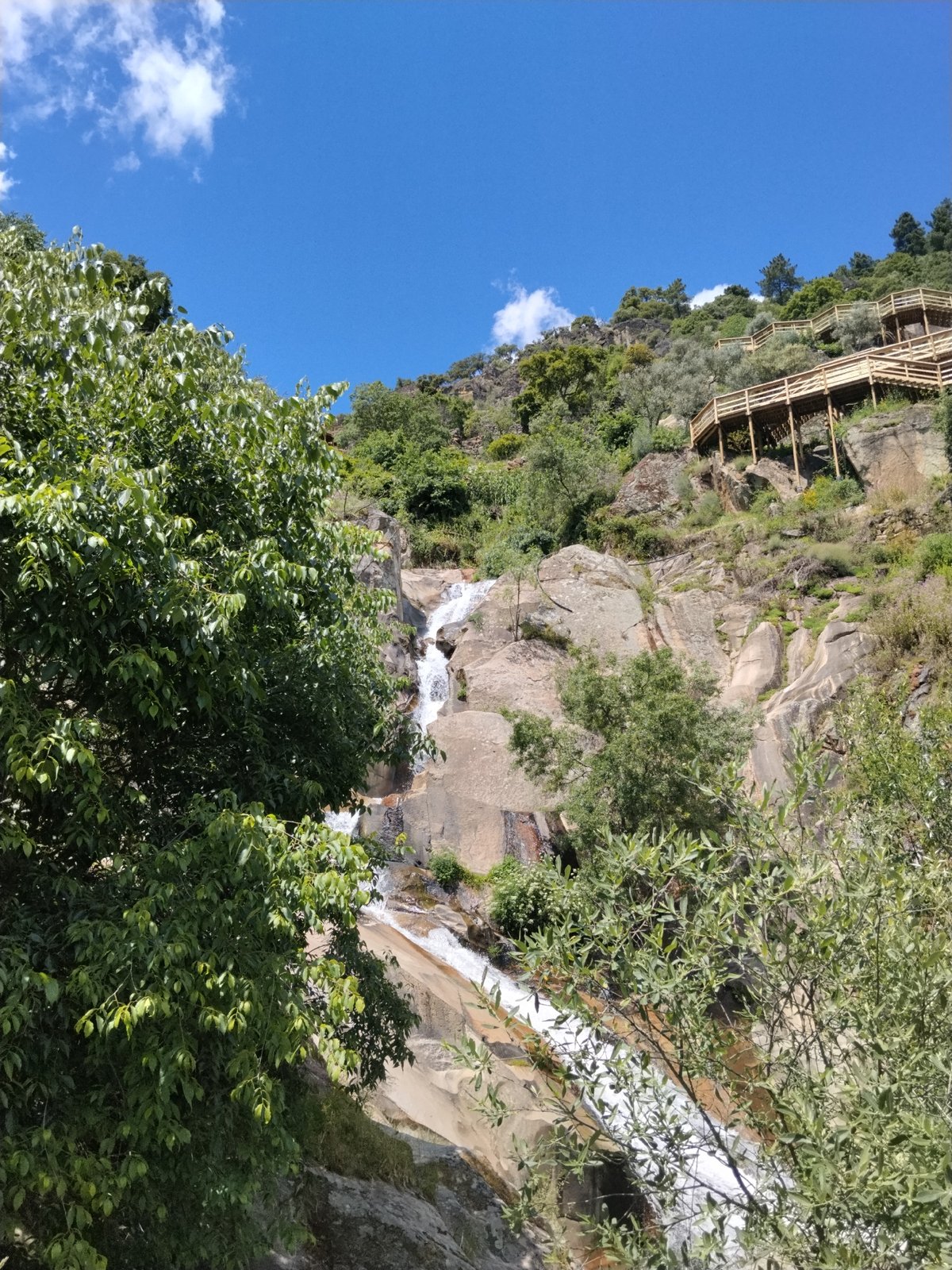 Waterfall observed flowing through green landscape in Alijó, Portugal