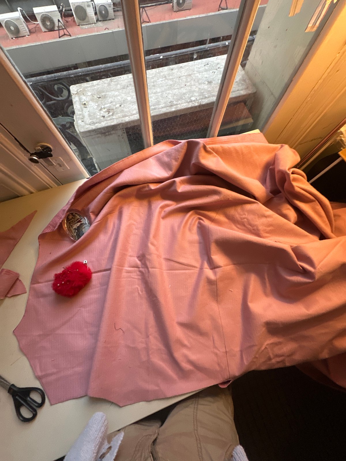 Buenos Aires resident examines wrinkled corduroy fabric indoors