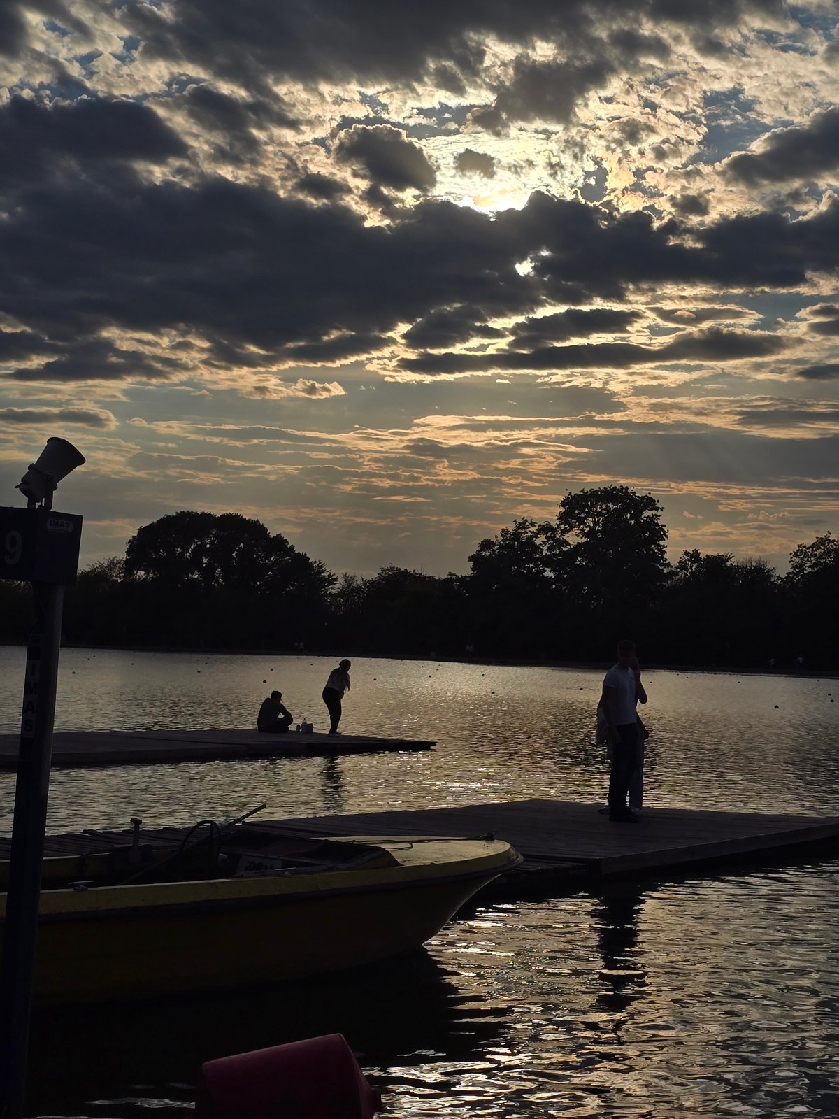 Kayaker paddled lake waters under dramatic evening skies