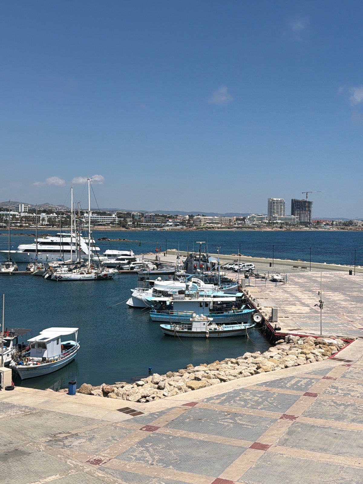 Tourist photographs Paphos harbor and waterfront attractions in Cyprus