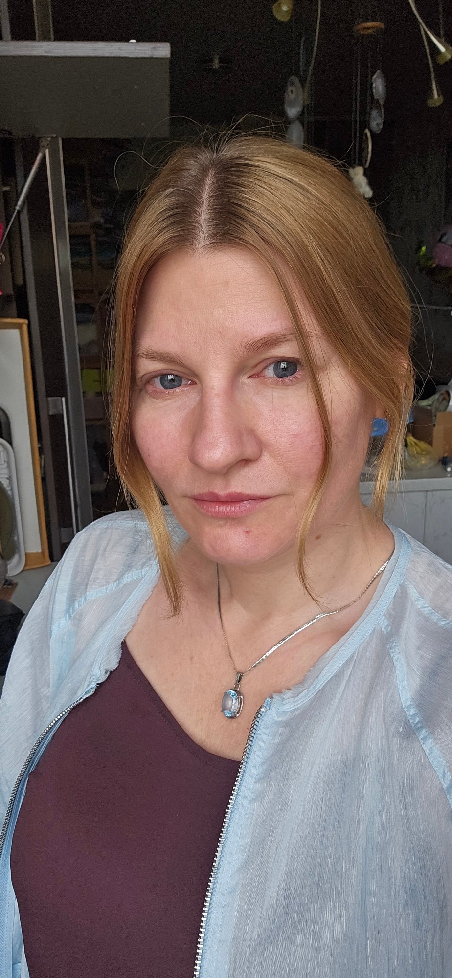 Portrait in Krasnodar, light blue jacket and silver pendant