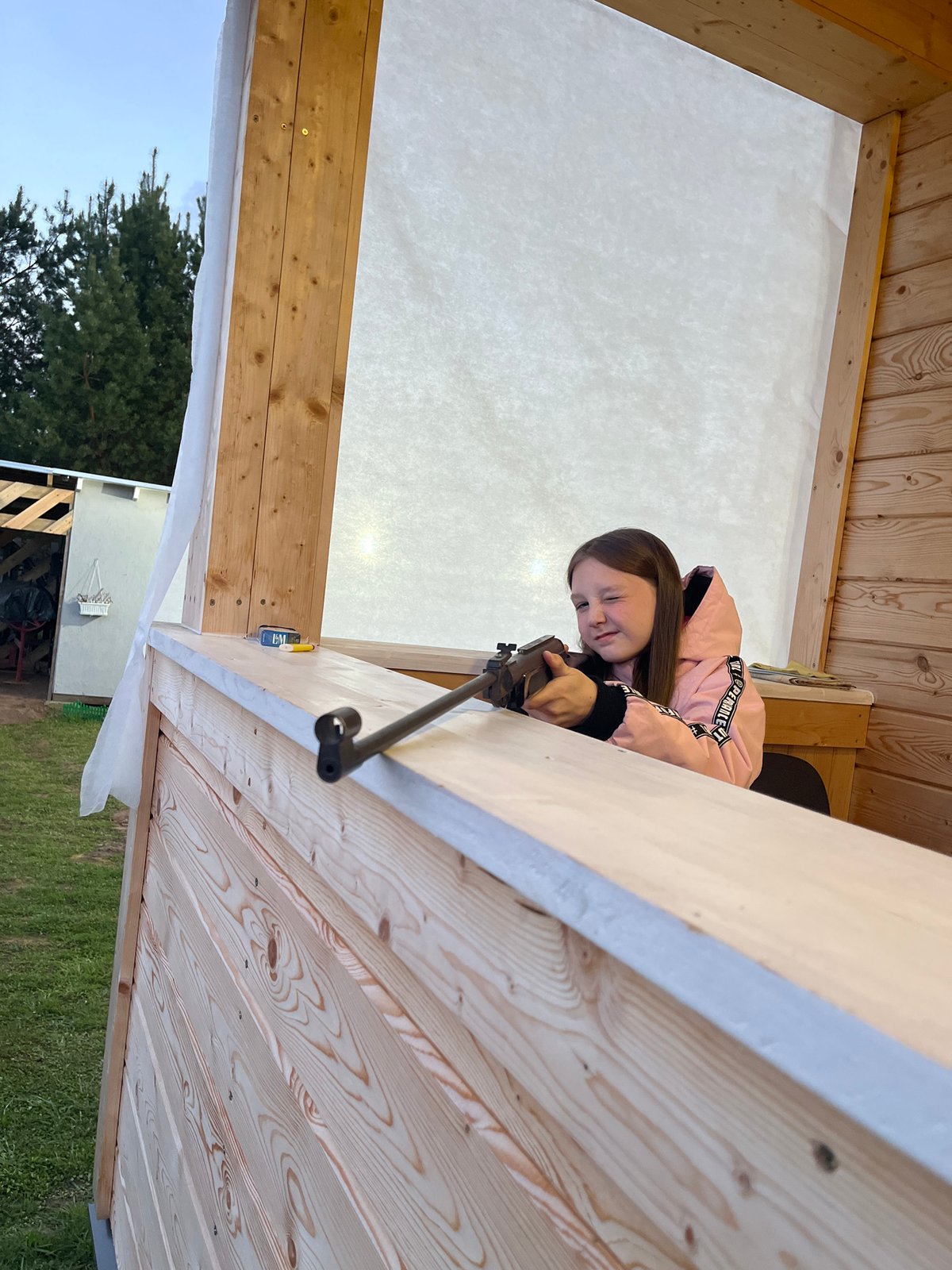 Girl practices shooting during stormy afternoon in rural Russia