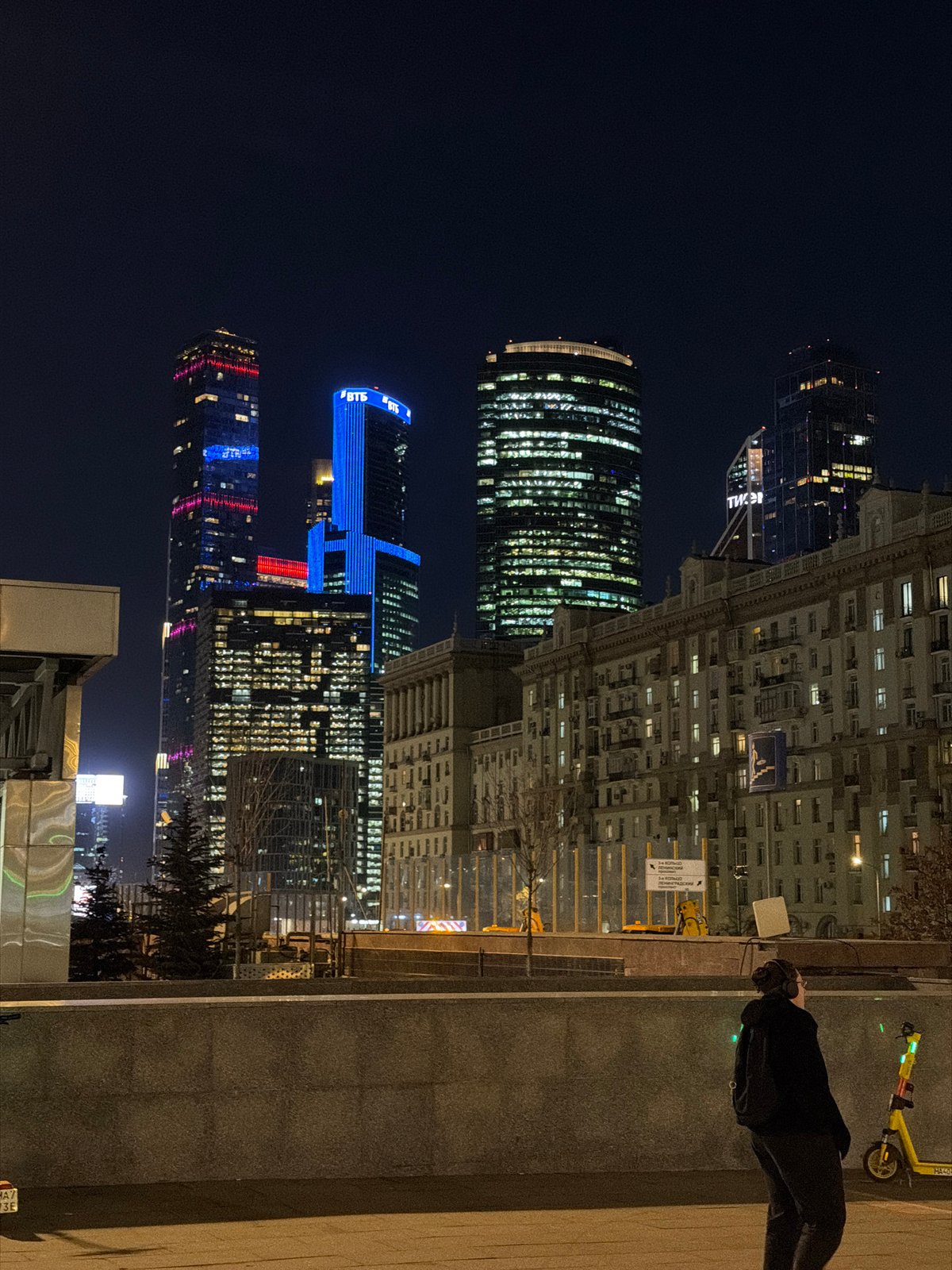 Moscow skyscrapers illuminate night sky with colorful architectural lighting