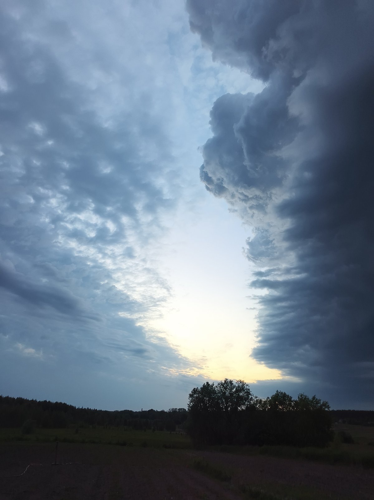 Dramatic storm clouds gather over Ukrainian farmland near Vyshevychi