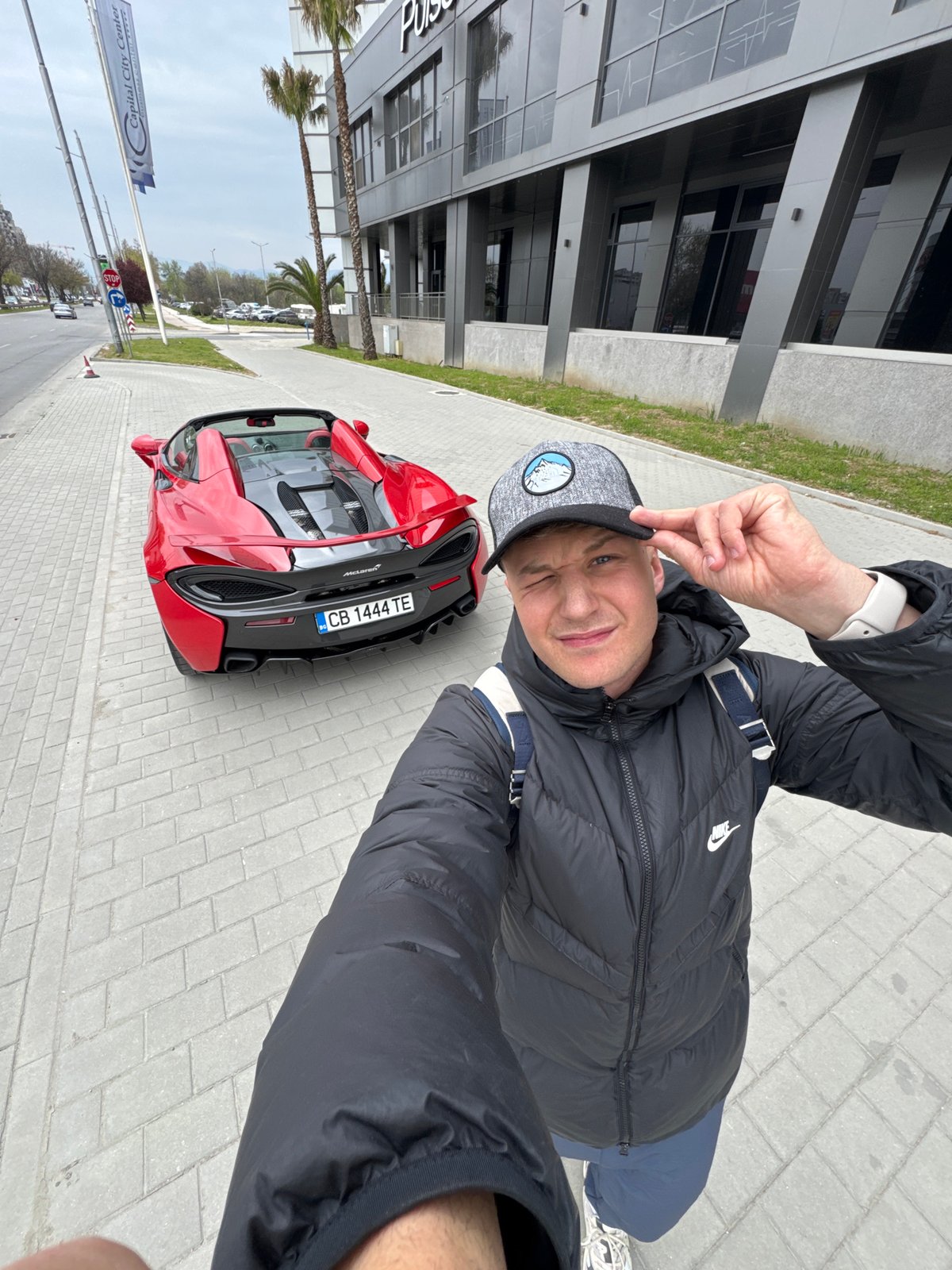 Man poses with red McLaren in Plovdiv, Bulgaria
