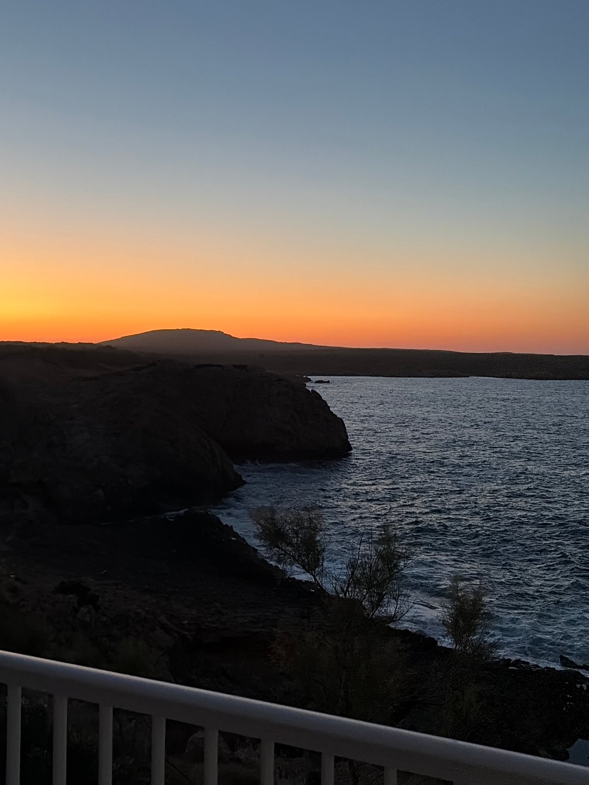 Rocky coastline meets a fading sunset in Menorca