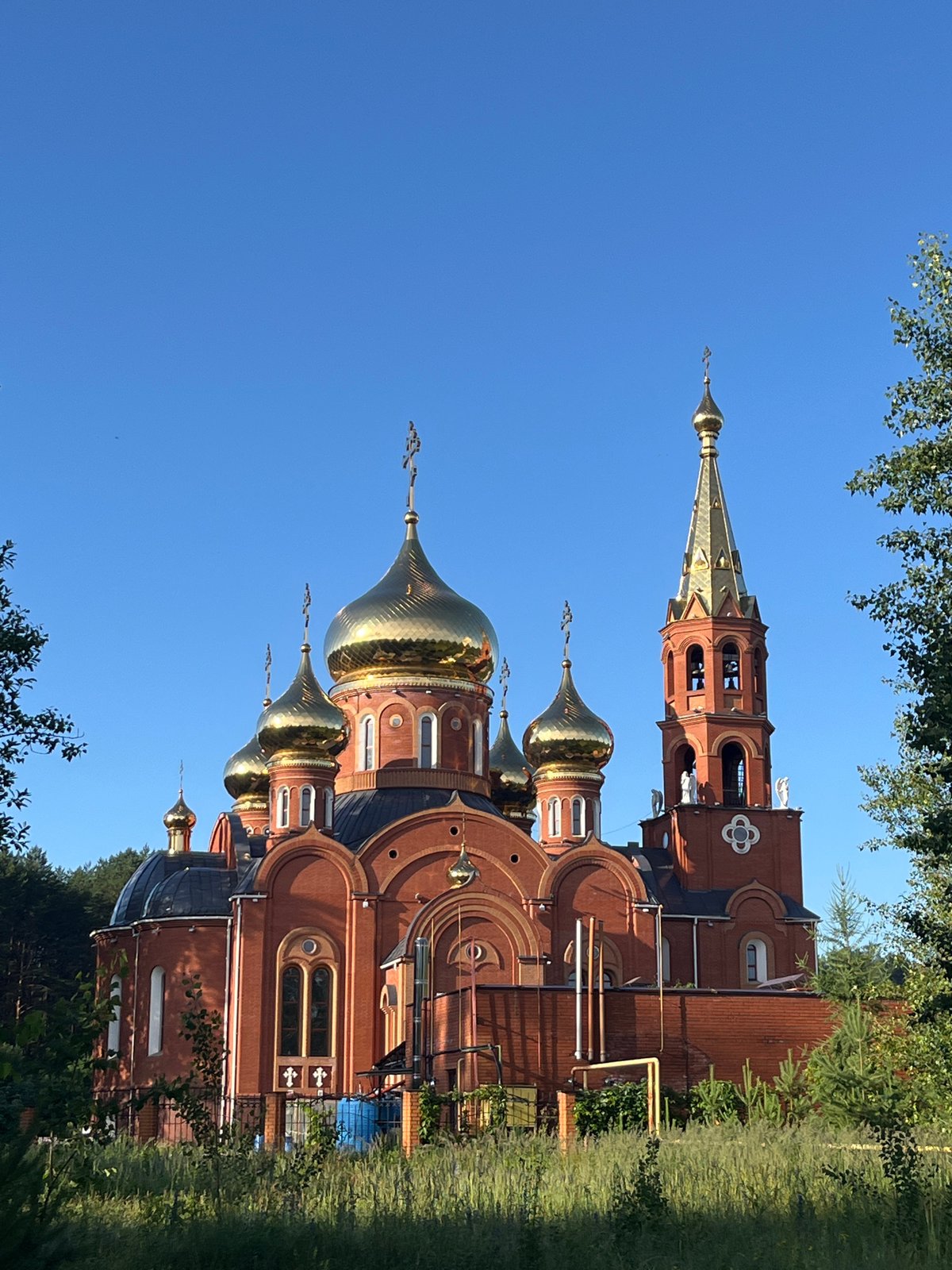 Cycling past a golden-domed church in Chaikovsky, Russia