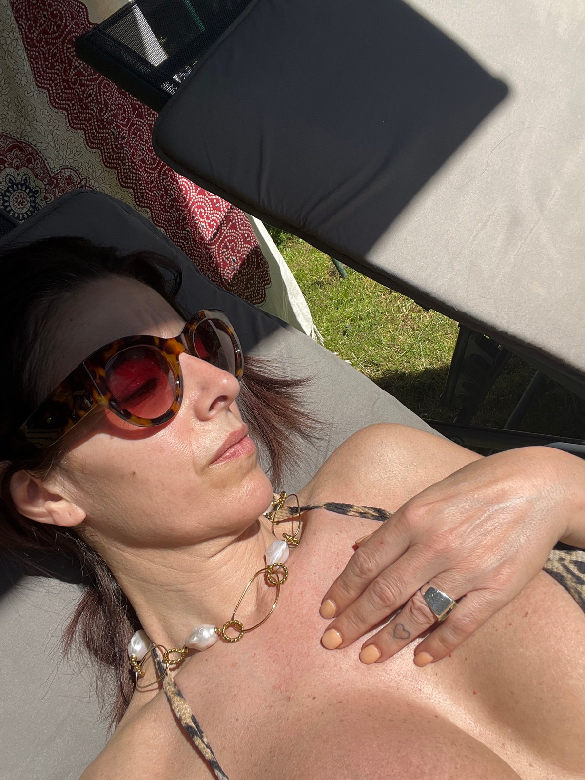 Woman sunbathes in garden during midday in Konz, Germany