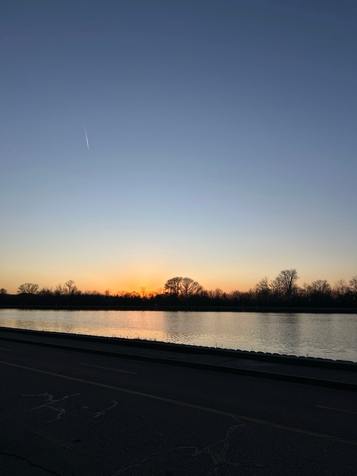 Cyclist rides riverside path during sunset in Plovdiv