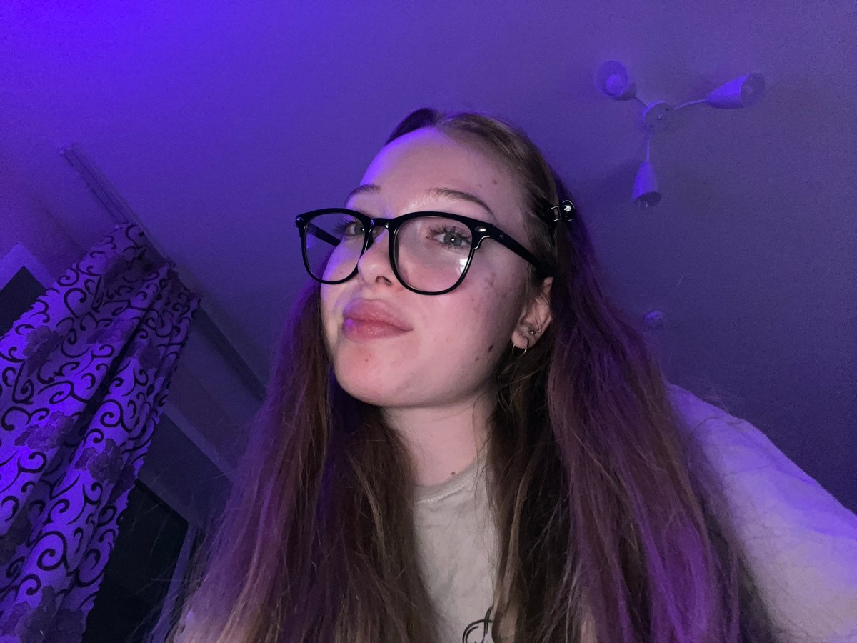 Woman takes selfies with cat in LED-lit room