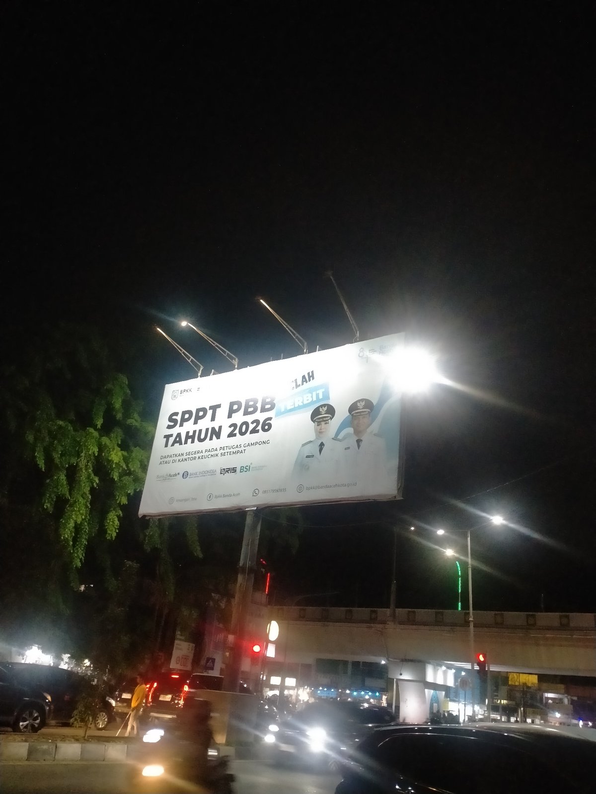 Property tax billboard illuminated at night in Banda Aceh