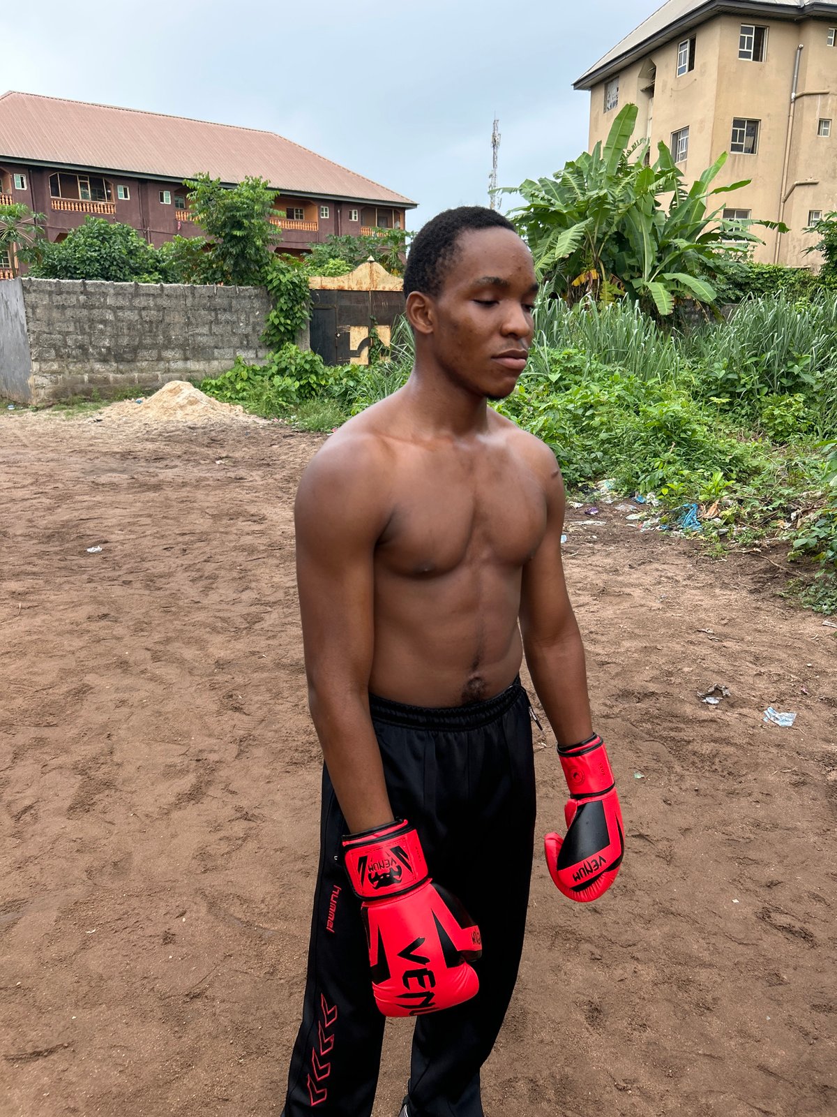 Informal boxing training session on a dirt lot in Ihiagwa