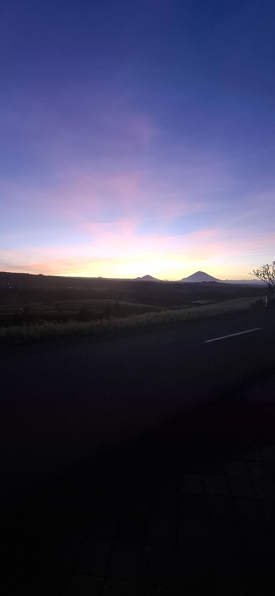 Evening sky gradient observed over terraced mountains in Penebel