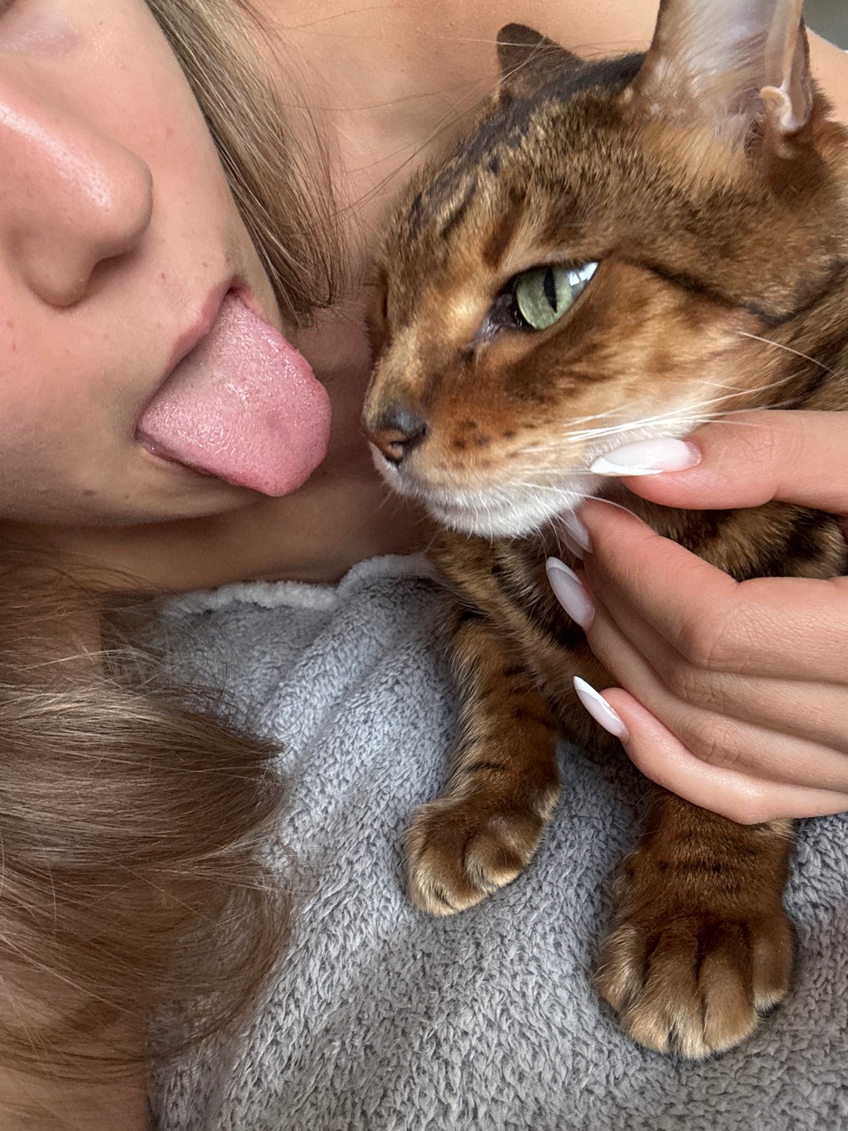 Woman and Bengal cat share quiet domestic afternoon moments