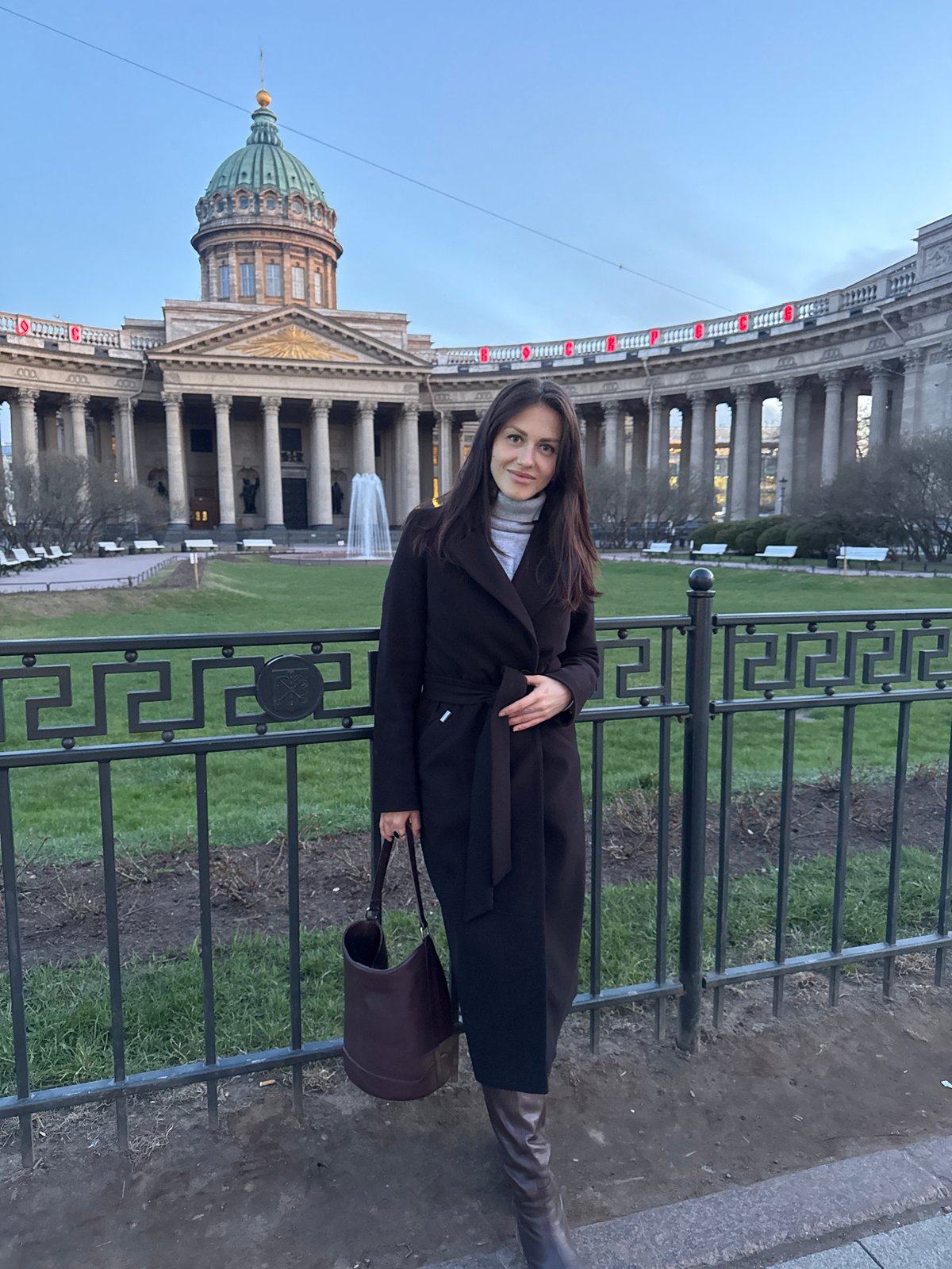 Woman poses for photo at Kazan Cathedral in Saint Petersburg