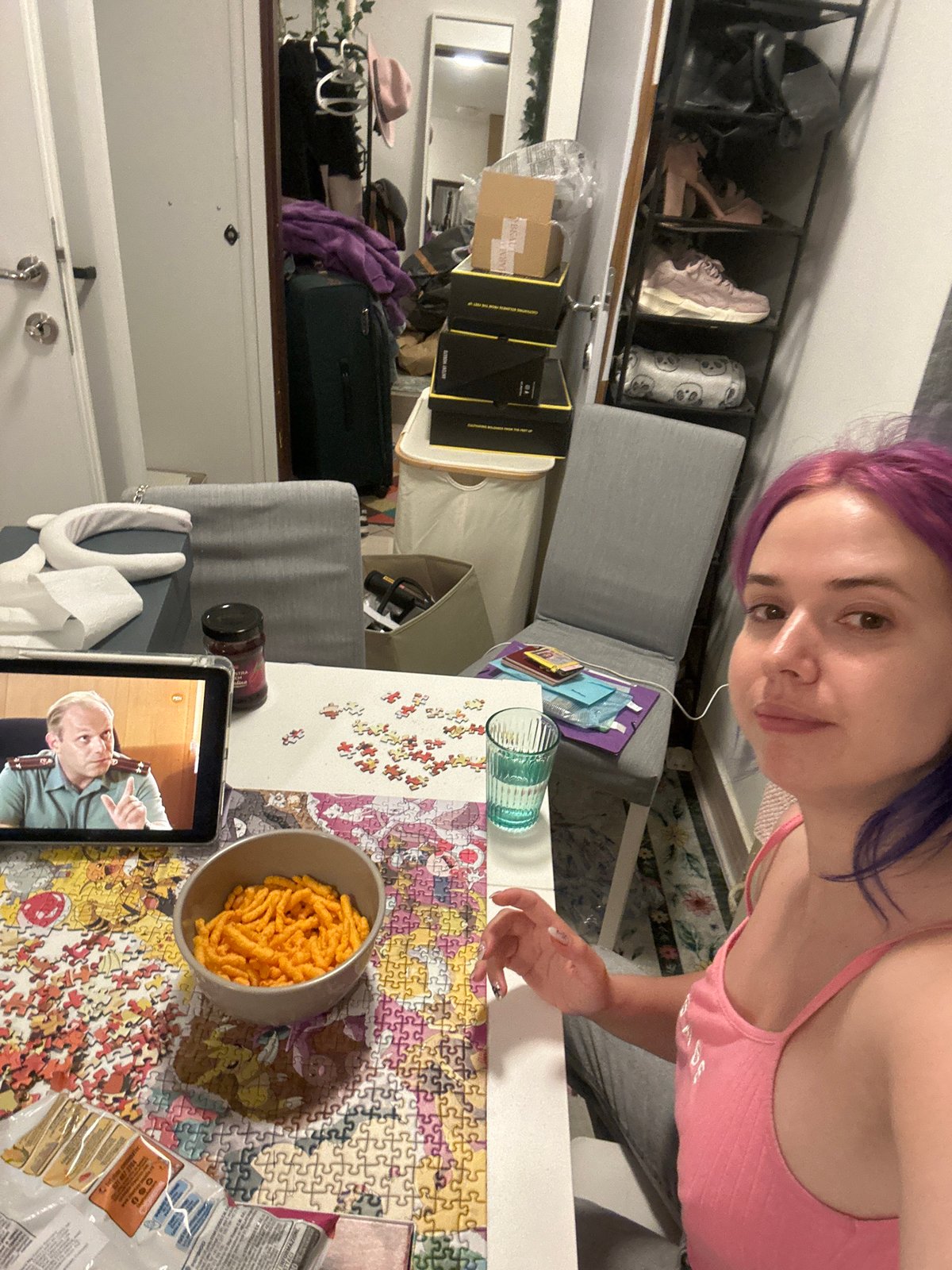 Woman enjoys puzzle and snacks in Zagreb evening scene