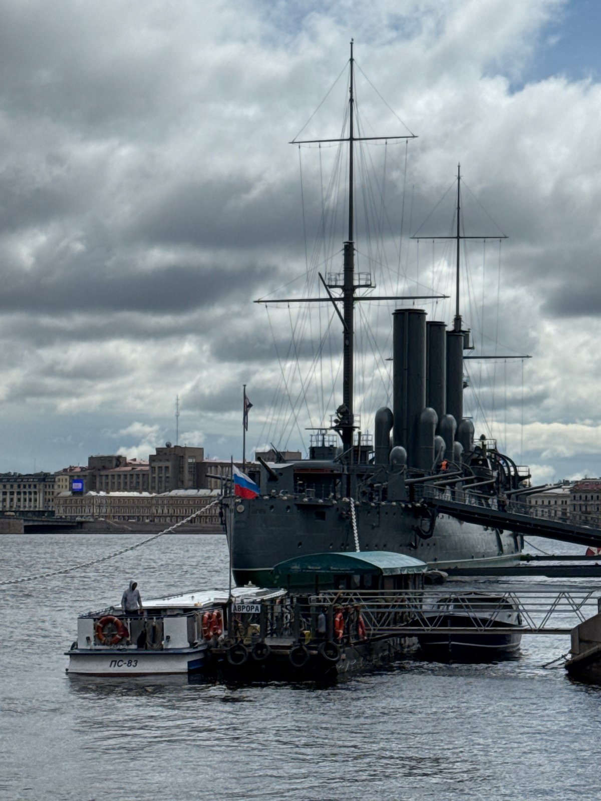 Tourists visit historic Cruiser Aurora along Saint Petersburg waterfront