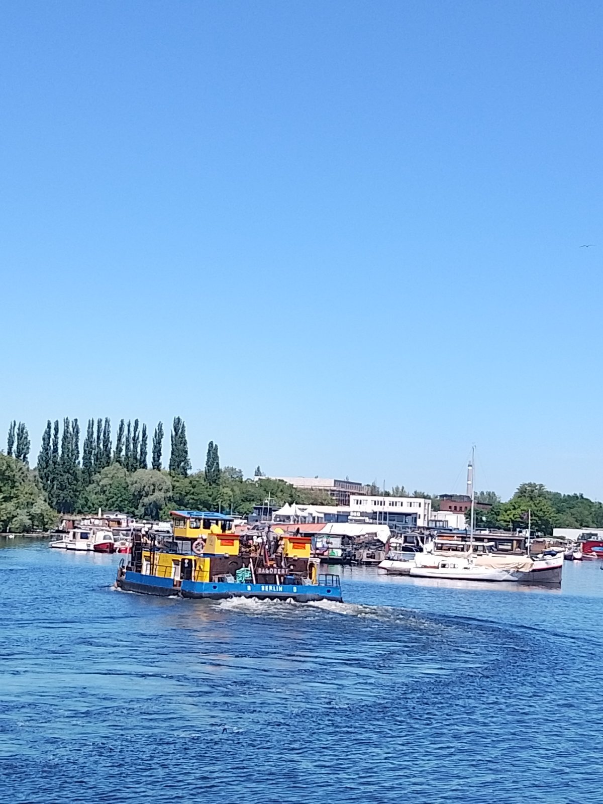 Mixed vessel traffic observed on sunny waterway Friday afternoon