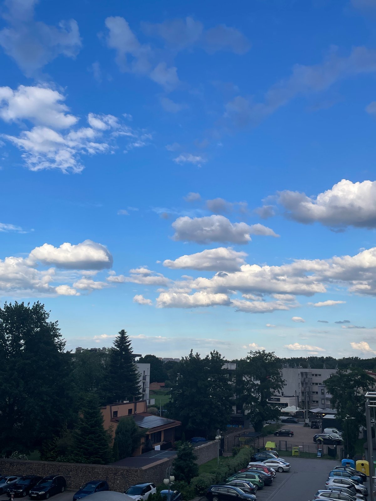 Dramatic clouds gather over residential district as observers document sky